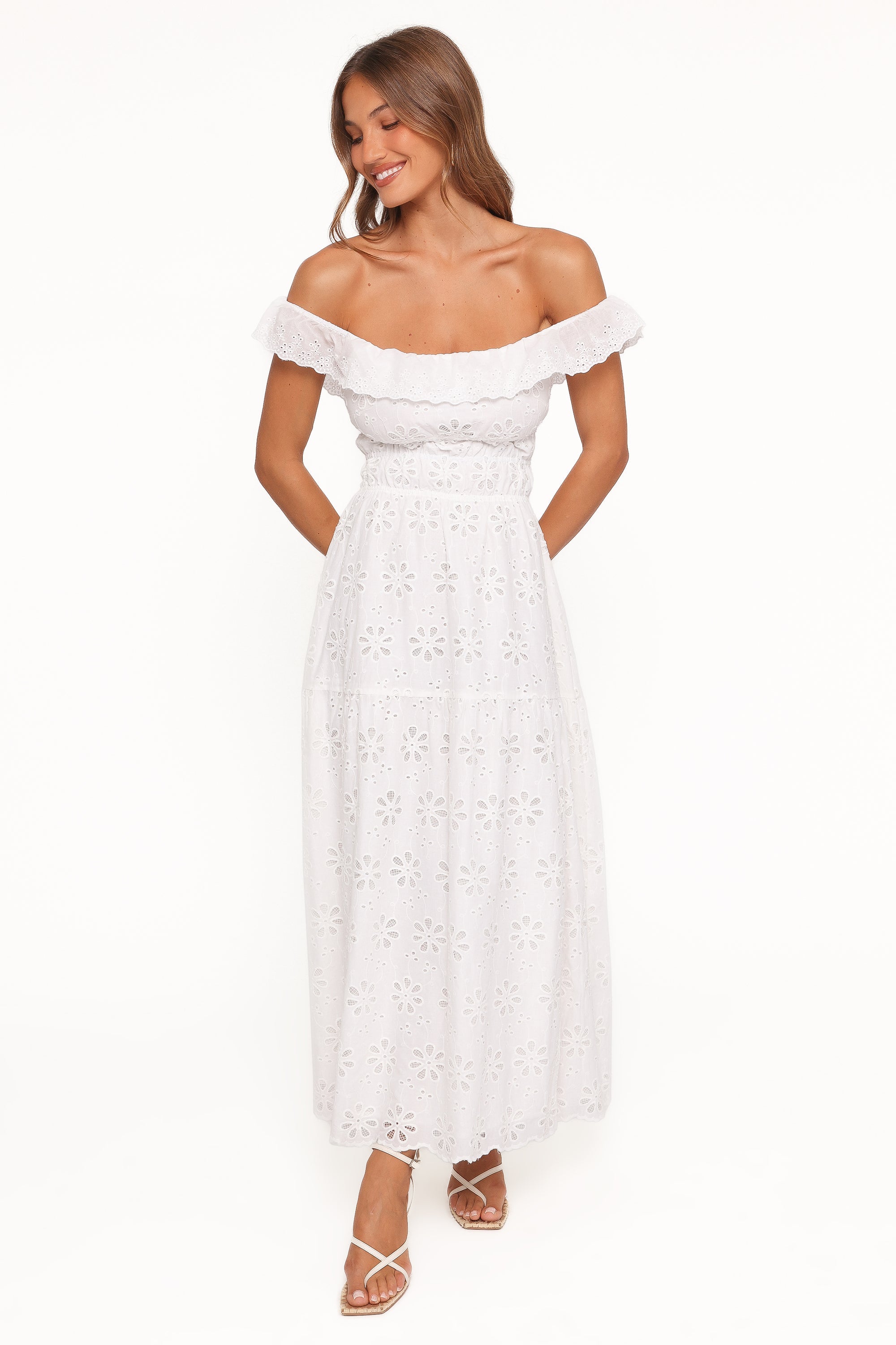 White broderie off-shoulder maxi dress with delicate embroidery and a flowing silhouette, perfect for vacations, bridal showers, weddings, and summer events.