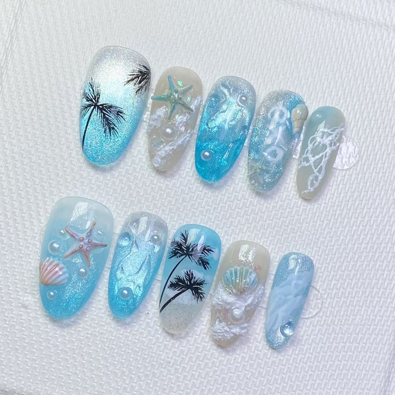 Ocean-inspired press-on nails featuring 3D starfish, seashells, palm trees, and mermaid-style blue gradients. Perfect for summer beach vacations and coastal looks.