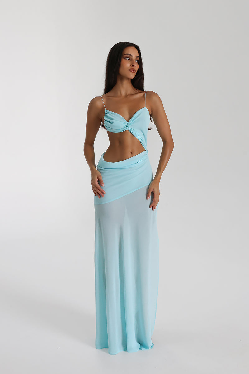Cutout Maxi Dress.Daring waist cutouts, and a flowing sheer-overlay skirt, this ethereal piece is perfect for your next luxury coastal getaway.