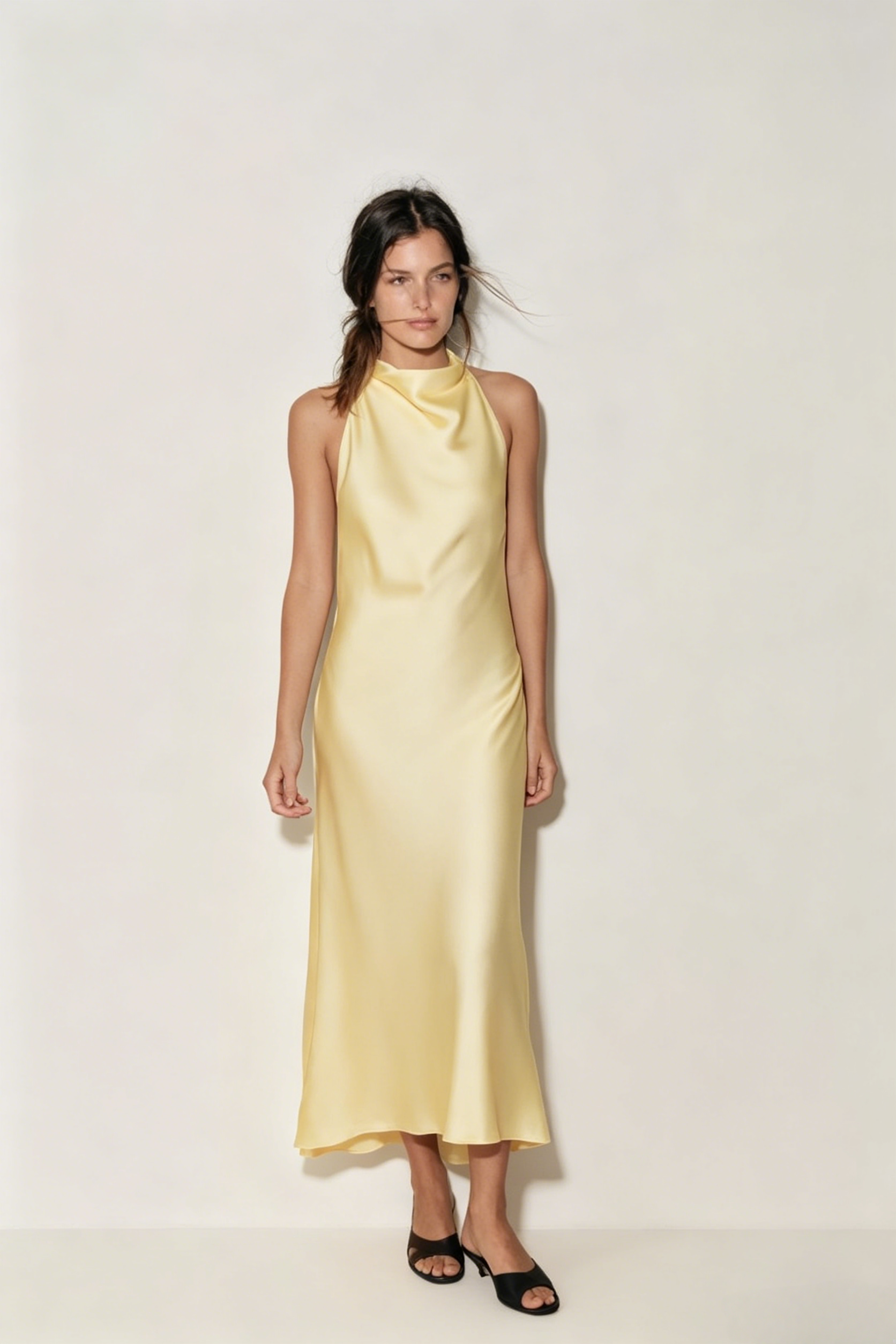 Buttery Yellow Satin Halter Maxi Dress. Chic high-neck halter silhouette—the perfect sophisticated choice for your next sunset vacation event.