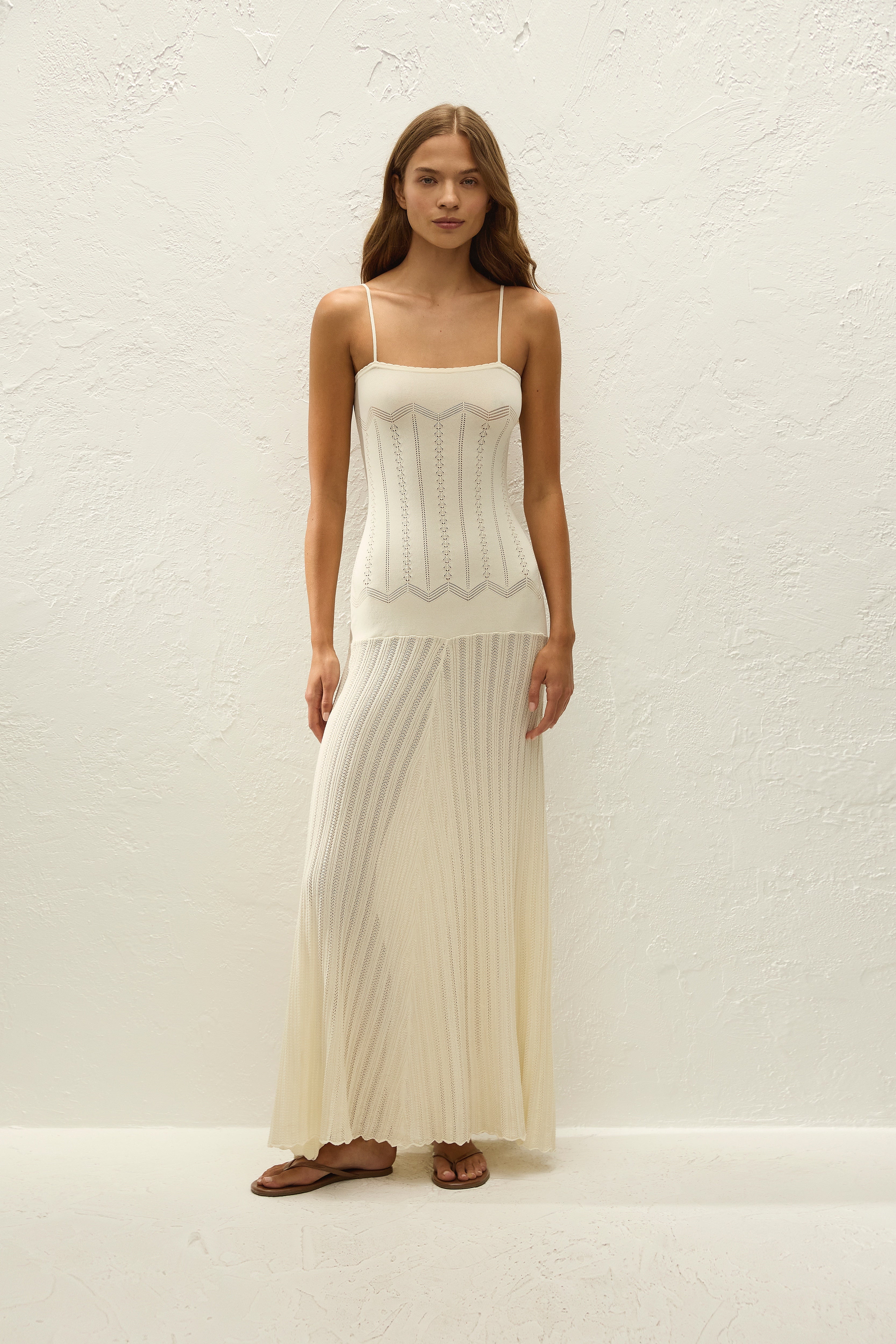 Ivory Crochet Knit Dress. Intricate knit textures, and a graceful floor-length silhouette—the ultimate elegant choice for your summer resort wardrobe.