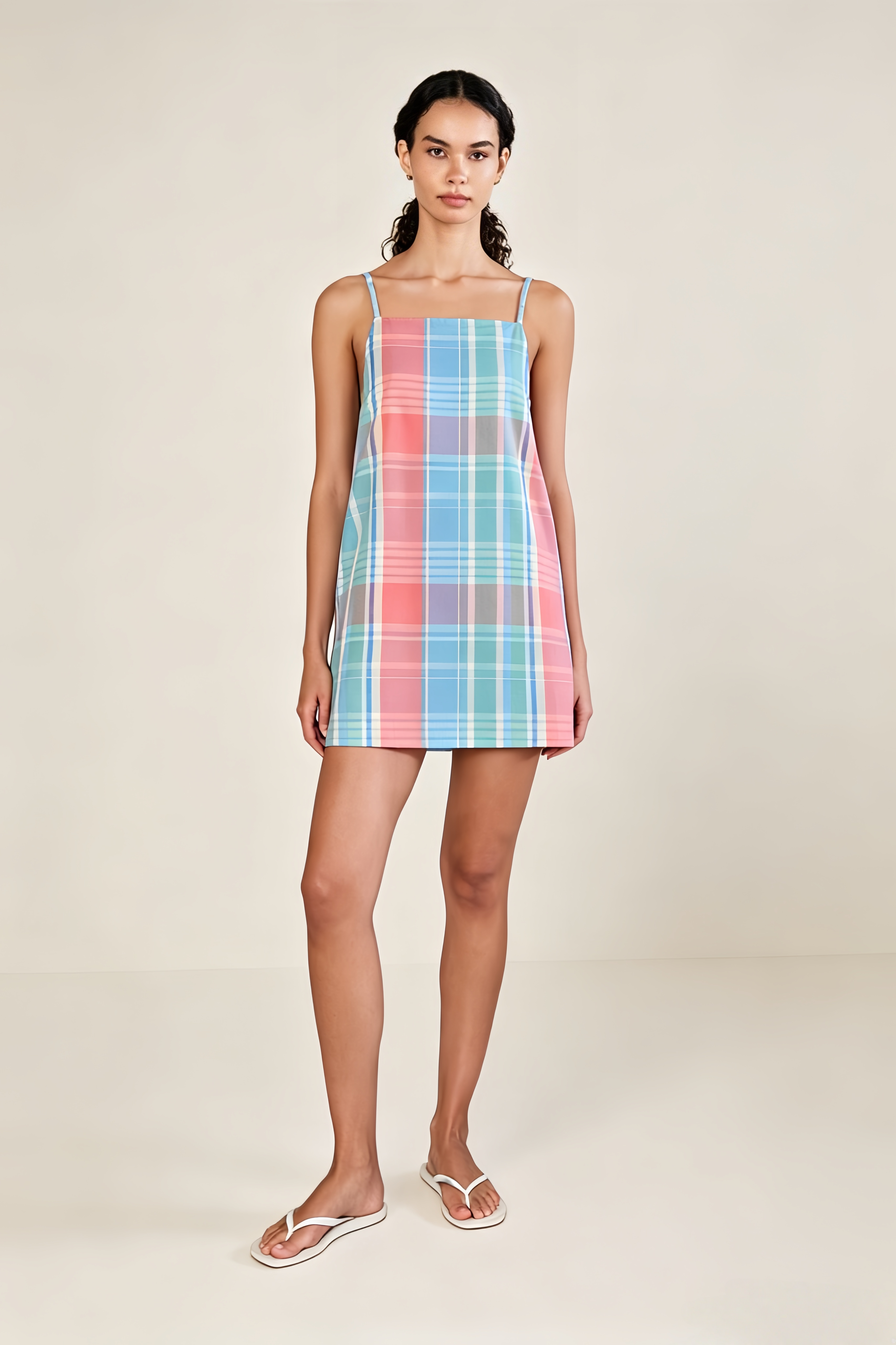 Plaid Mini Slip Dress. Featuring a nostalgic plaid pattern, a clean square-neck silhouette—the perfect comfortable choice for your next sunny vacation escape.