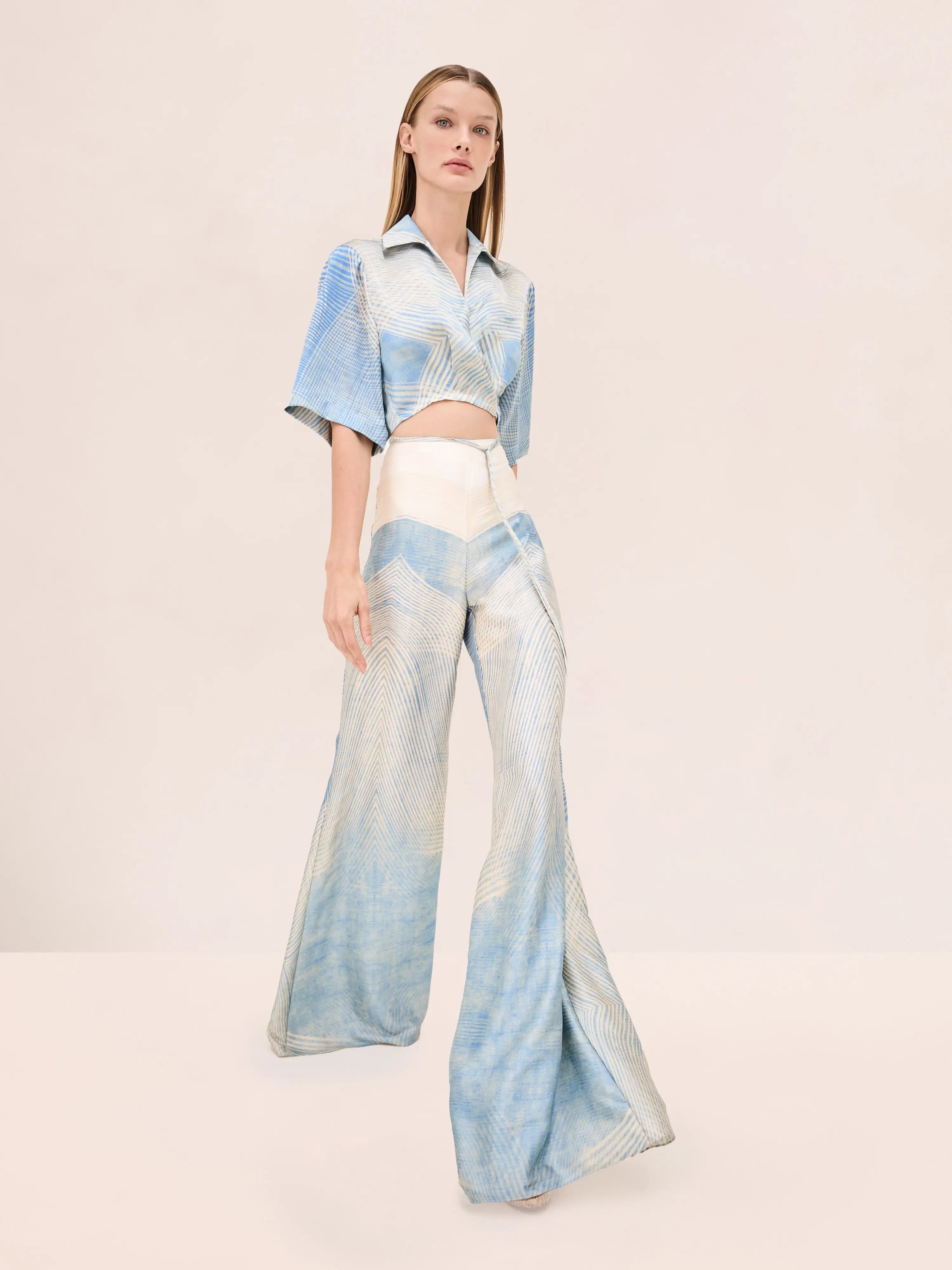 Elegant blue and ivory two-piece set featuring a cropped shirt and wide-leg pants. Perfect for vacations, resorts, cruises, and summer styling.