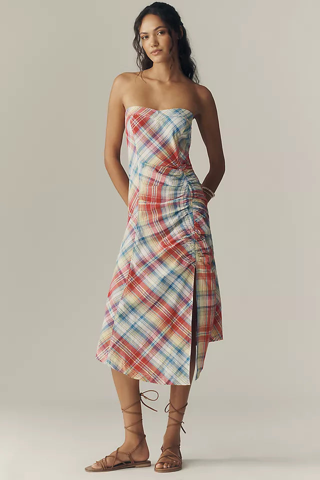 Plaid Ruched Strapless Midi Dress. Flattering ruched side detail, and a chic strapless silhouette—the perfect effortless piece for your next sun-drenched getaway.