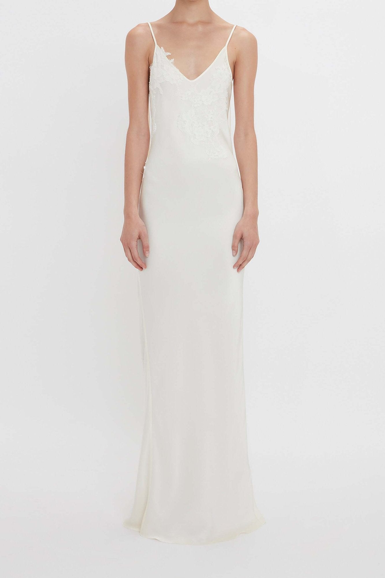 Elegant ivory satin maxi dress featuring delicate floral lace detailing and a flattering slip silhouette. Perfect for bridal events, weddings, and formal occasions.