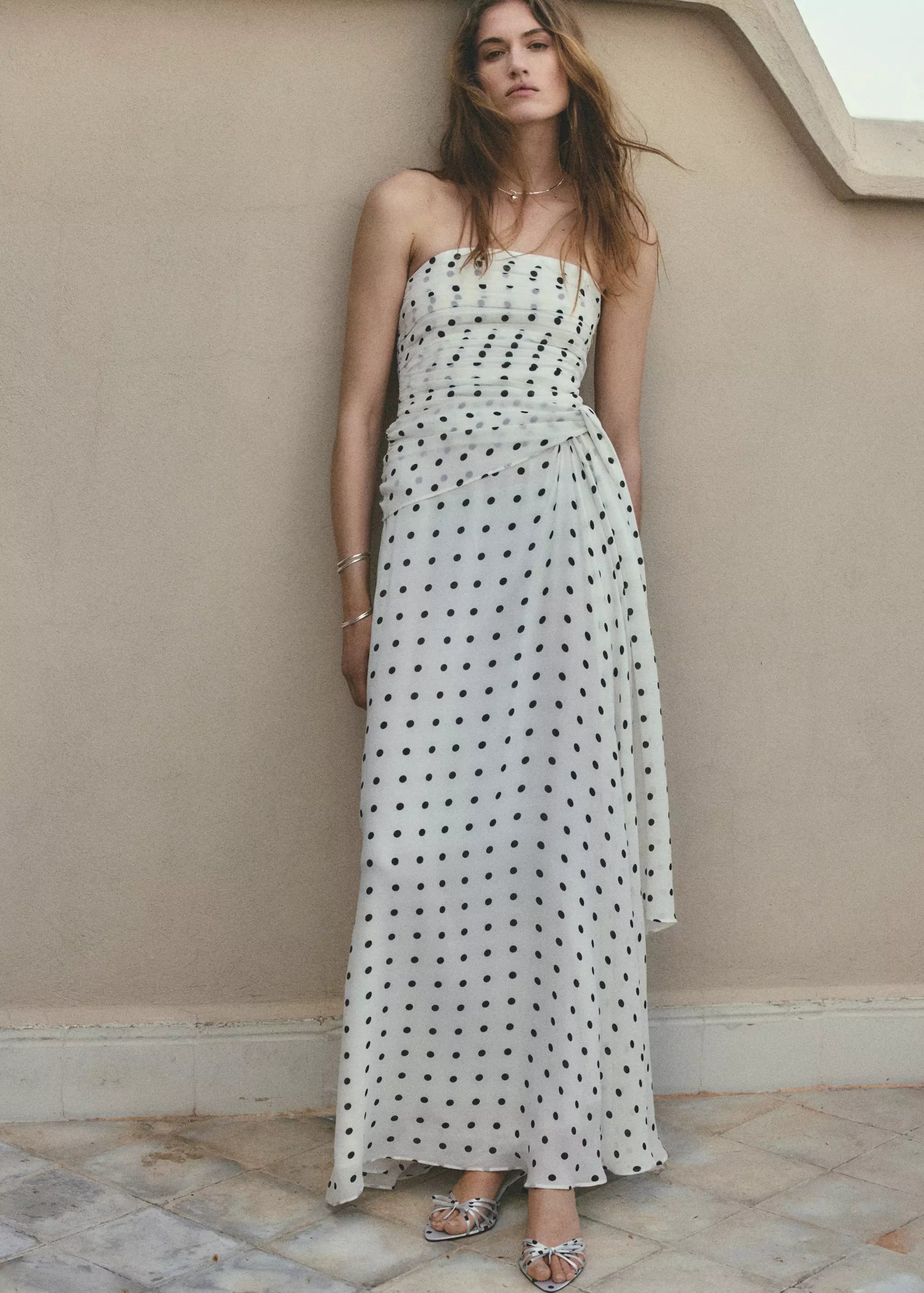 Elegant polka dot strapless maxi dress featuring a ruched bodice and flowing silhouette. Perfect for vacations, weddings, parties, and summer occasions.