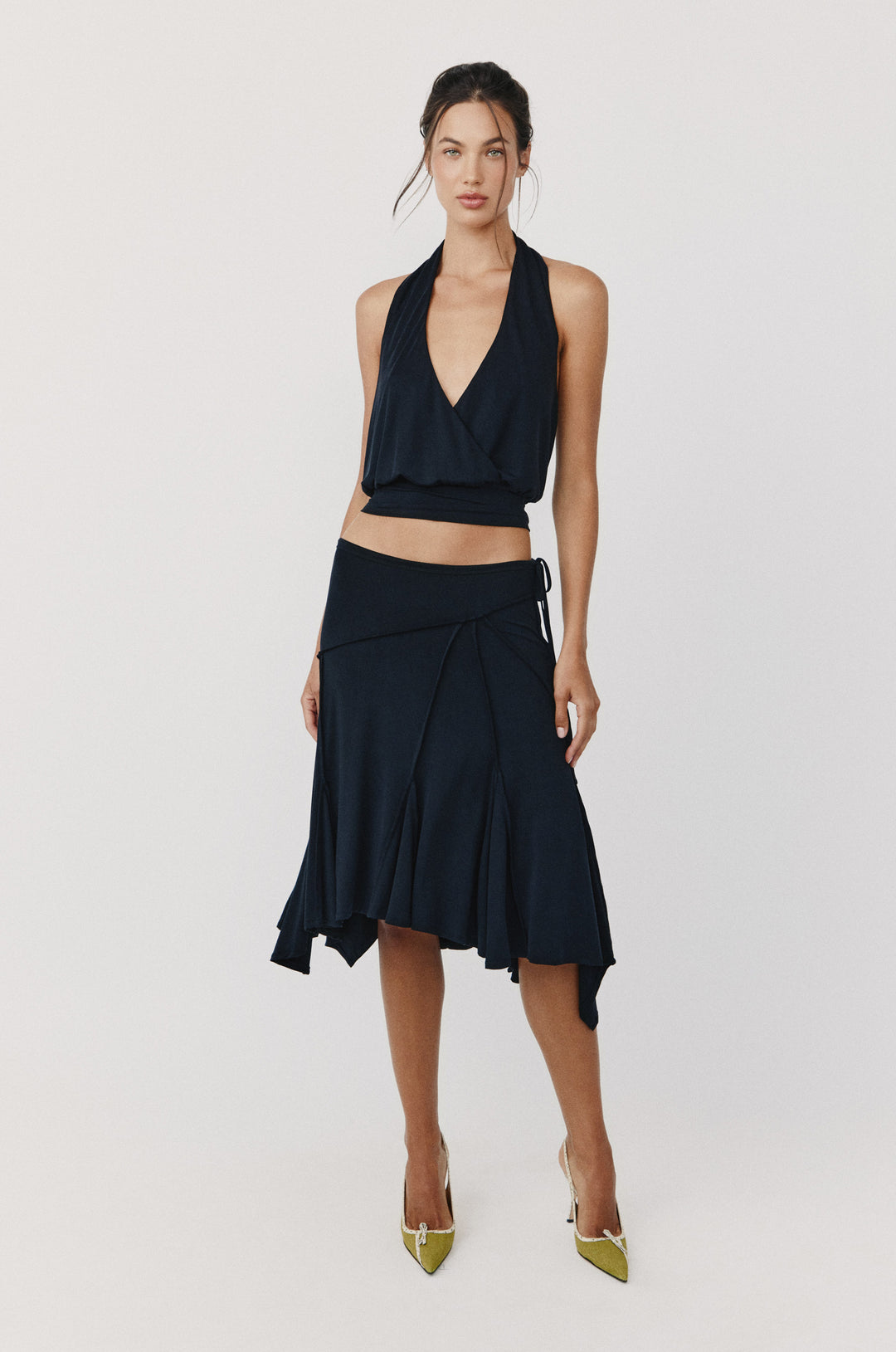 Asymmetrical Draped Set . Featuring a sleek halter top and artistic midi skirt for elevated summer evenings.