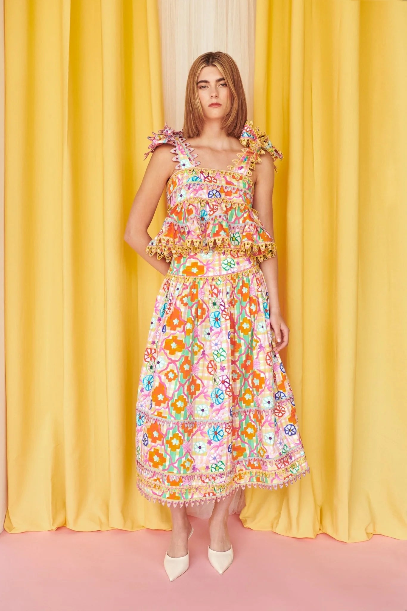 Multi-Print Eyelet Ruffle Co-ord Set. Featuring intricate eyelet lace trim, playful ruffles, and a bold, multicolored graphic print.
