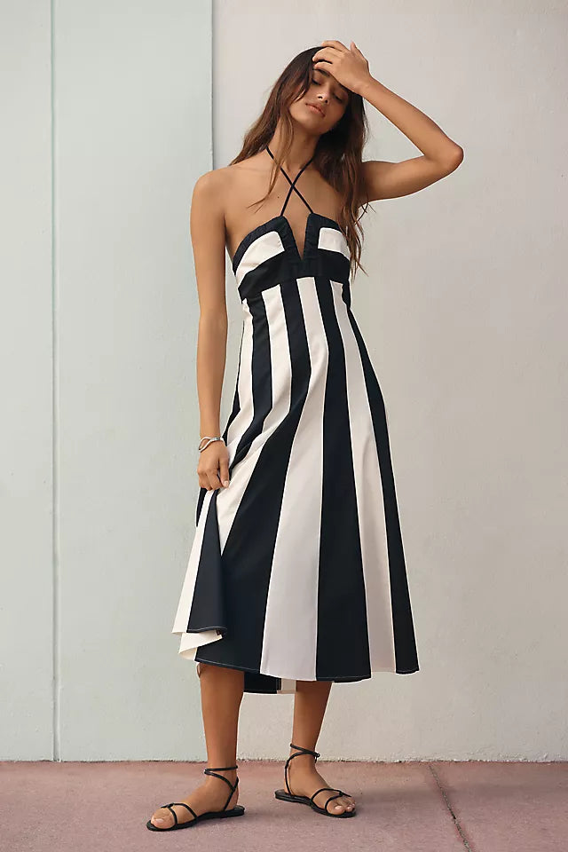 Bold Striped Halter Midi Dress. Featuring a classic halter neckline,and a flowy midi silhouette perfect for your summer holiday.