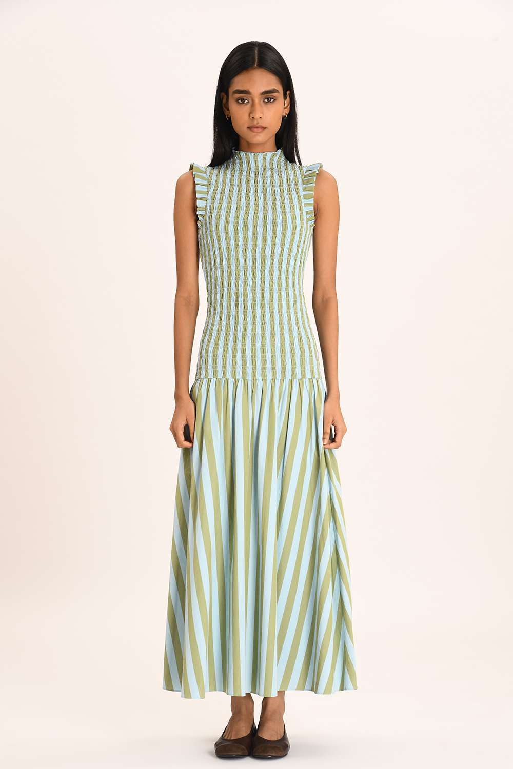 Striped Smocked Maxi Dress. Delicate ruffle shoulders, and a flowing striped skirt, this dress embodies effortless resort-chic style.
