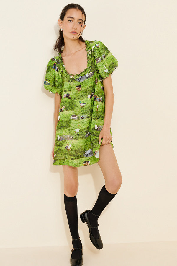 Whimsical Meadow Print Mini Dress. Delicate ruffle-trim neckline, and breezy puff-sleeve silhouette, this mini is a standout piece for your summer adventures.