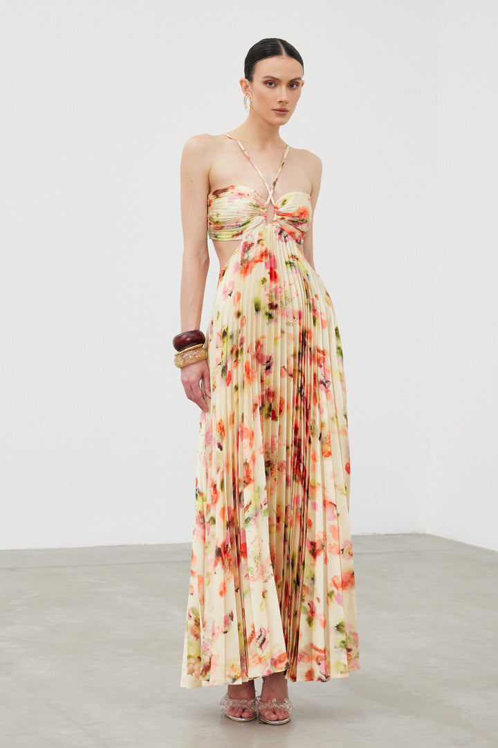 Floral Pleated Halter Maxi Dress. Alluring side cut-outs, and a flowing pleated silhouette, perfect for your next summer soirée.