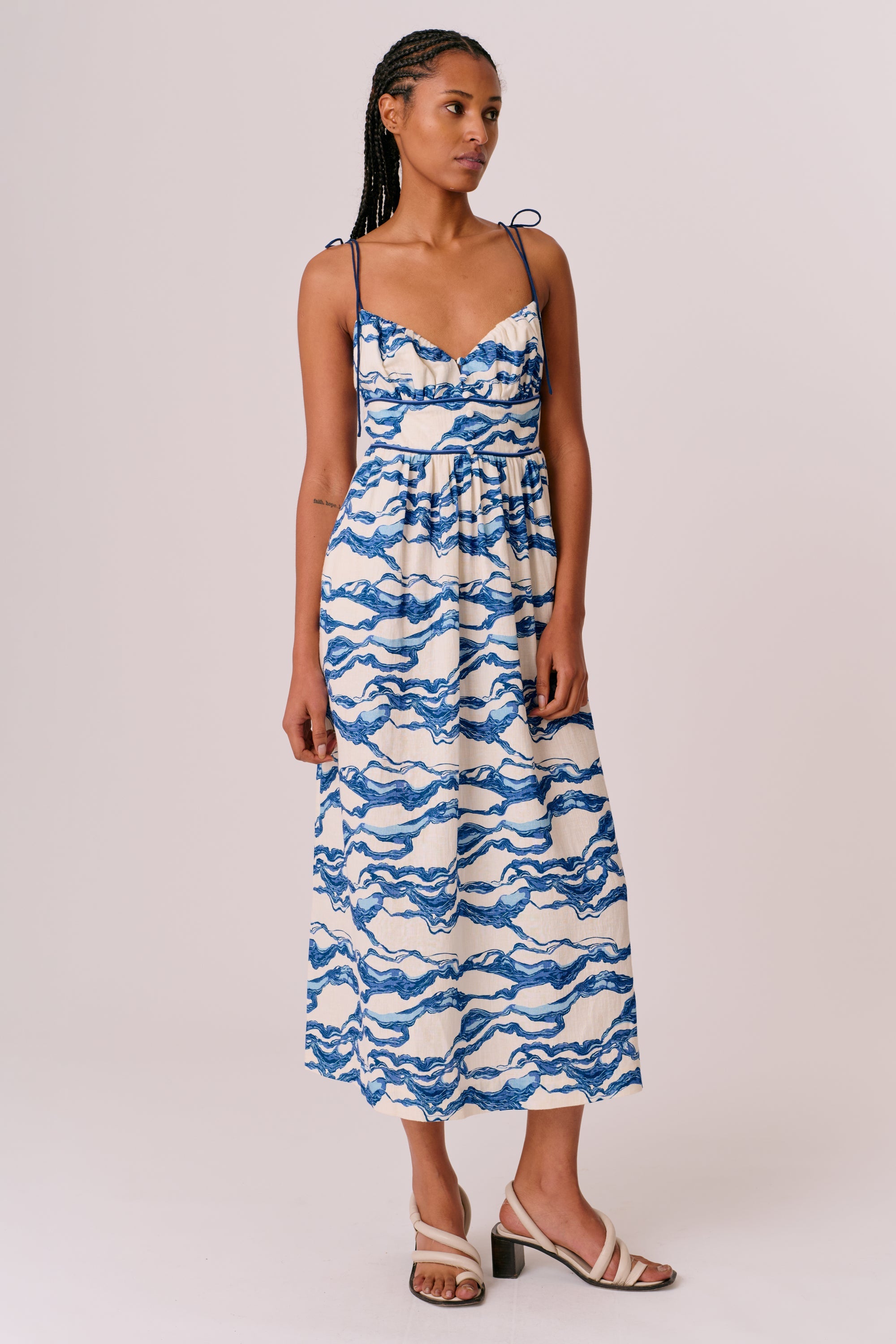 Artistic Wave Print Midi Dress. Featuring a unique abstract wave motif, delicate shoulder ties, this dress is the perfect addition to your  holiday wardrobe.