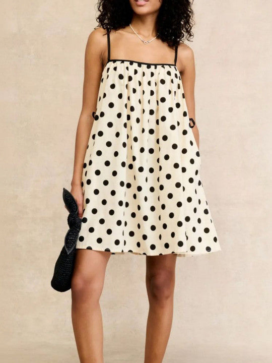 Polka Dot A-Line Mini Dress. Featuring a timeless monochromatic print, a breezy A-line silhouette, this mini is a versatile essential for your summer wardrobe.