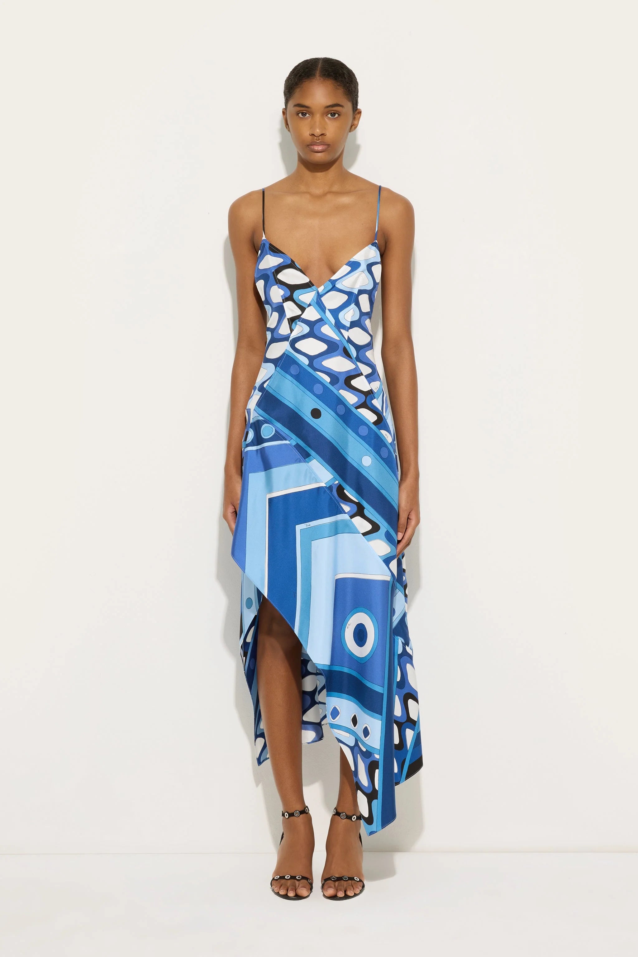 Geometric Art Slip Dress. Featuring a bold blue geometric print, a modern asymmetrical hem,this dress is the ultimate statement piece for elevated summer evenings.