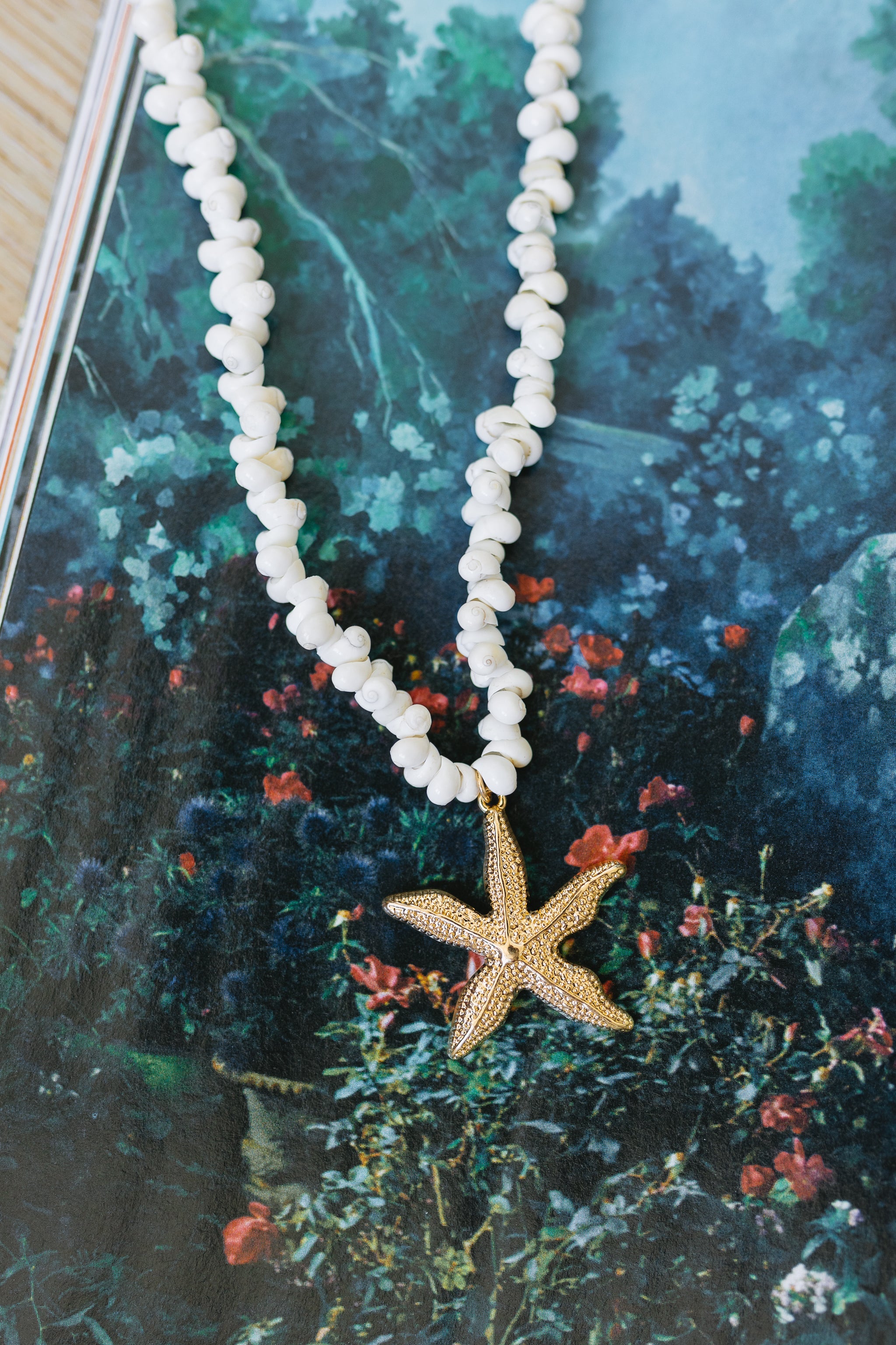 Coastal Starfish & Shell Beaded Necklace. Featuring natural white shells and a sophisticated gold-tone starfish pendant—the perfect summer layering essential.