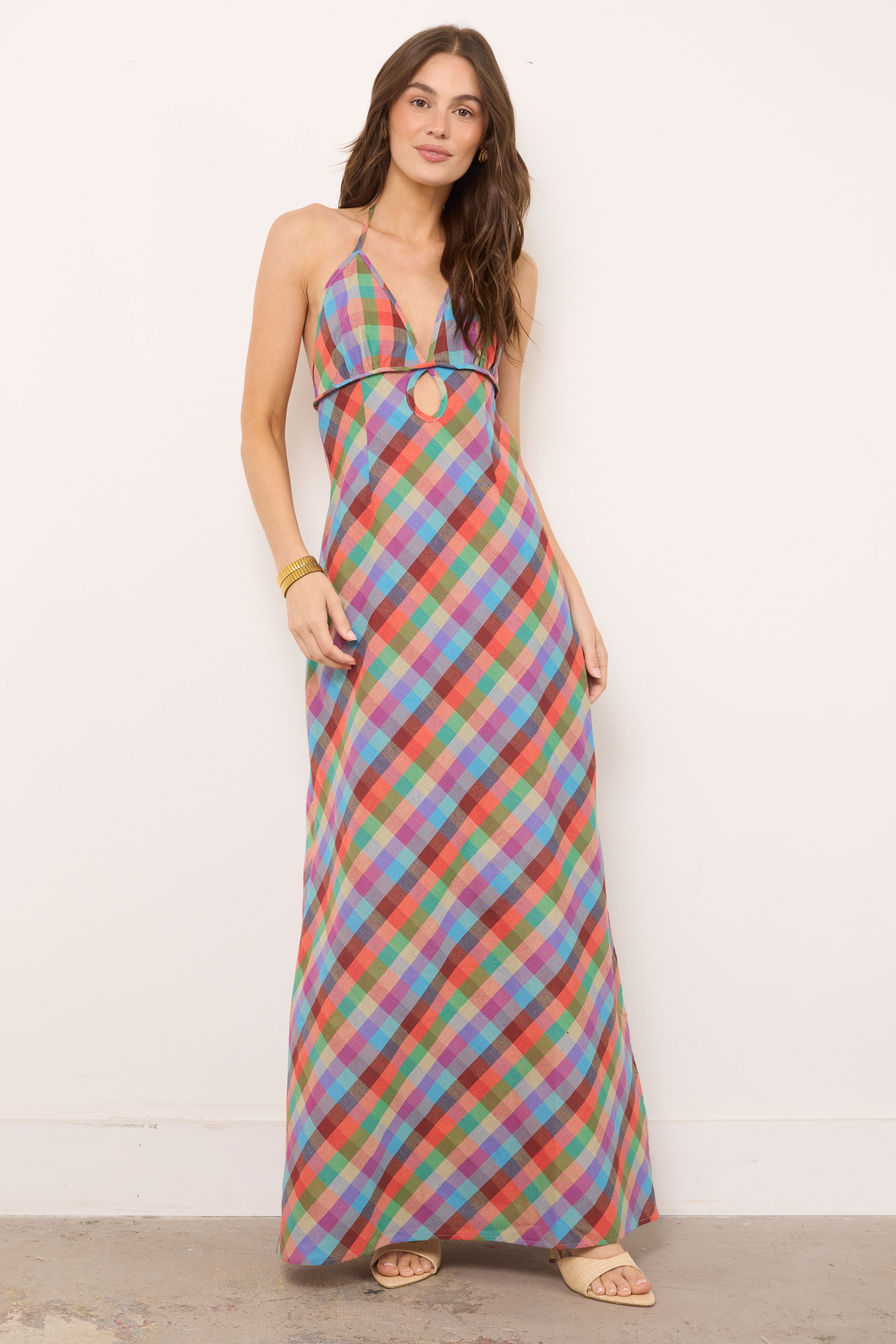 Plaid Halter Maxi Dress. Multicolored check print, an elegant halter neckline with chic cut-out detailing—perfect for your next sunny vacation escape.