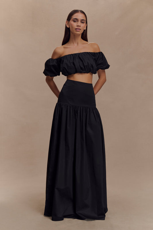 Midnight  Set. Featuring a dramatic puff-sleeve crop, high-waisted maxi skirt, this sophisticated black ensemble is the epitome of effortless resort glamour.