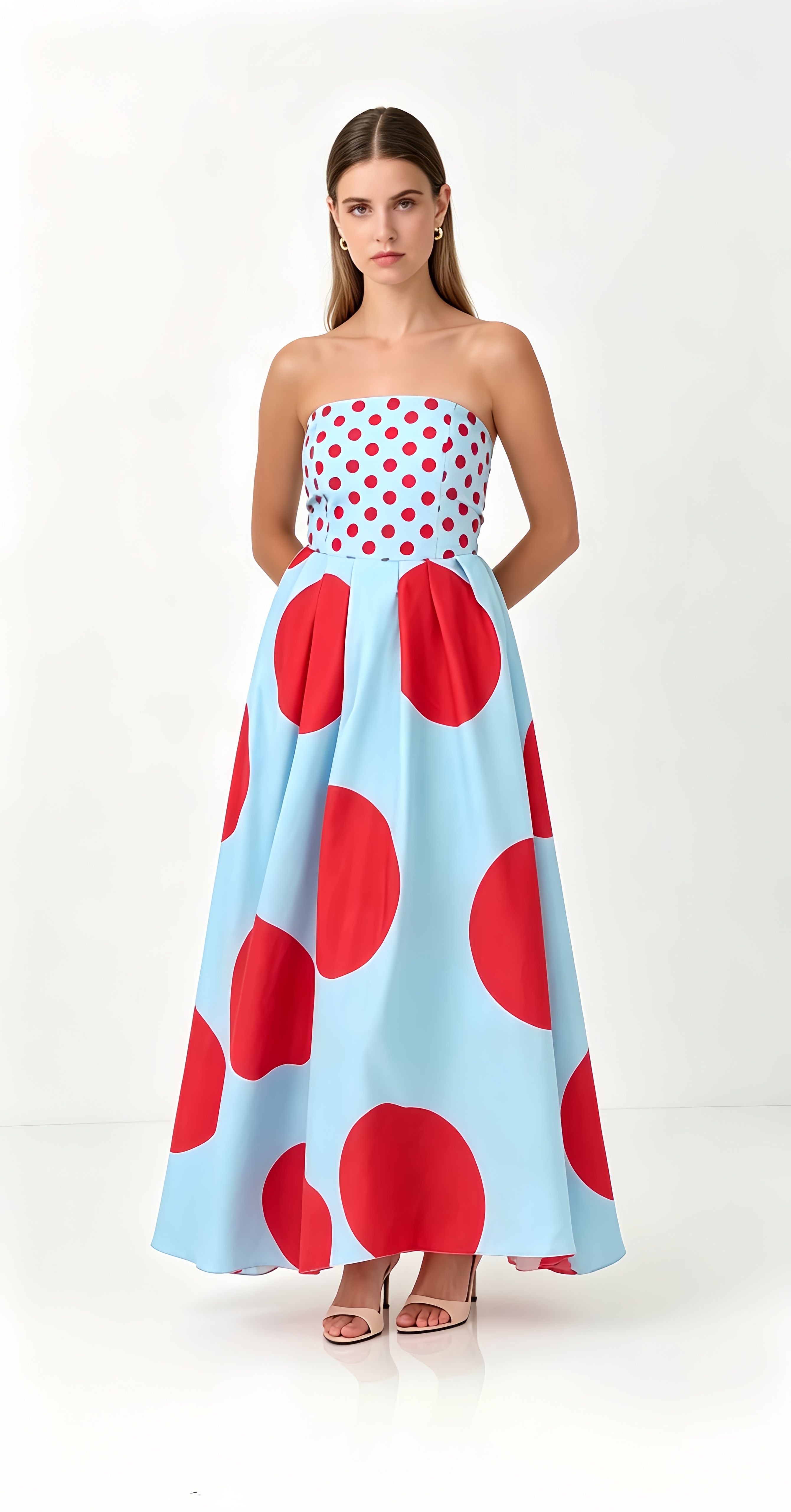 Featuring a vibrant red-on-blue polka-dot motif,structured pleated skirt,this gown is the ultimate statement piece for elevated summer soirées.