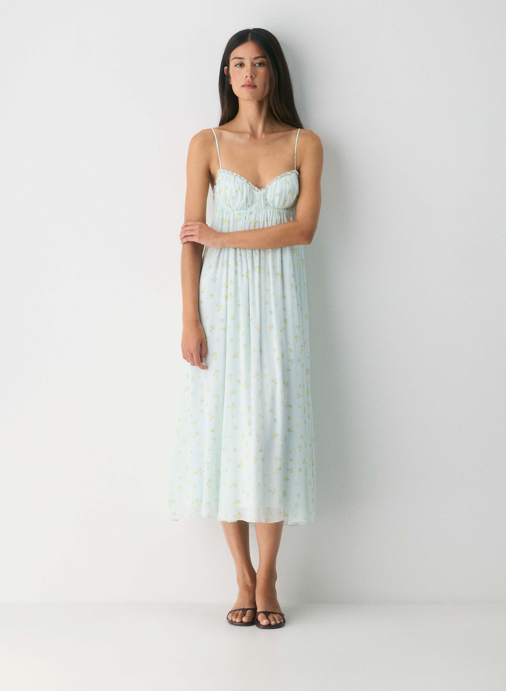 Featuring a dreamy pale blue hue with delicate yellow floral accents, a flattering bustier-style bodice—perfect for sun-drenched garden parties.