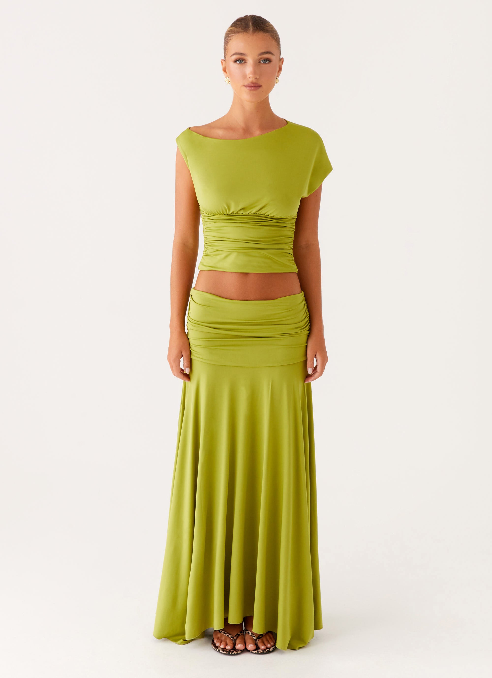 Featuring sophisticated ruched detailing, a flattering midriff-baring silhouette, this set is the ultimate statement piece for elevated summer soirées .