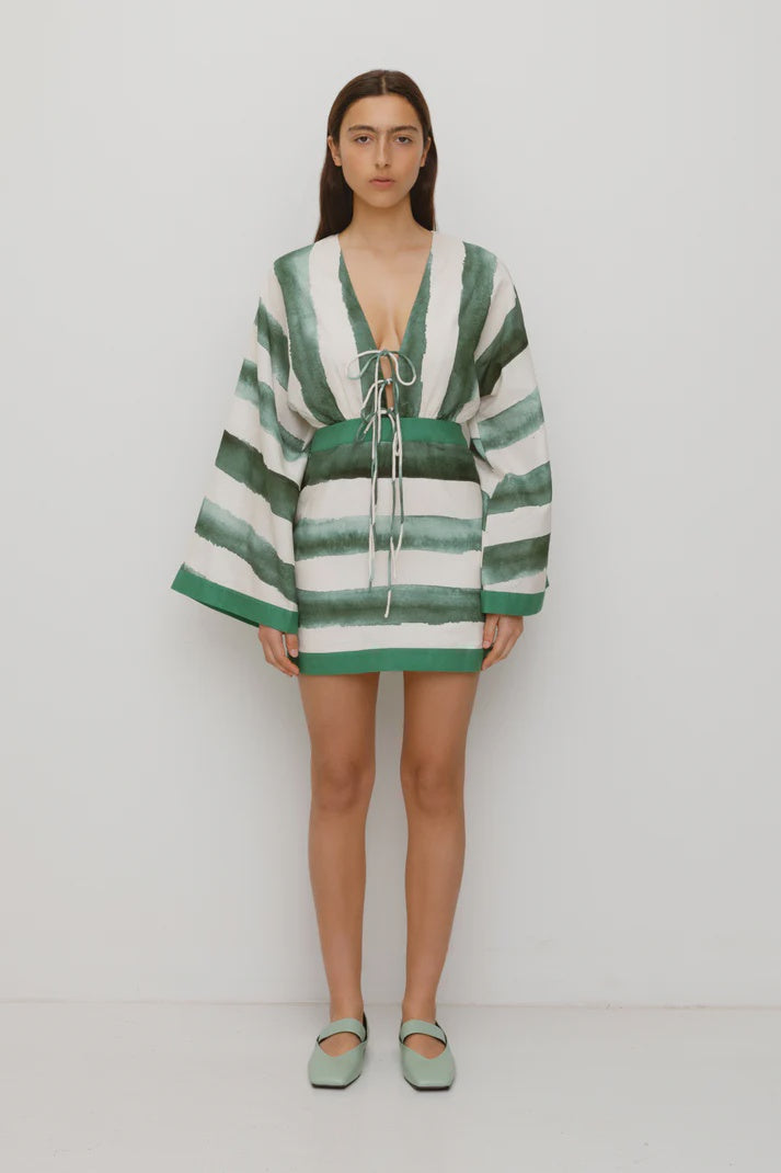 Featuring plunging tie-front neckline, and dramatic wide sleeves, this mini dress is the ultimate statement piece for sun-drenched afternoons.