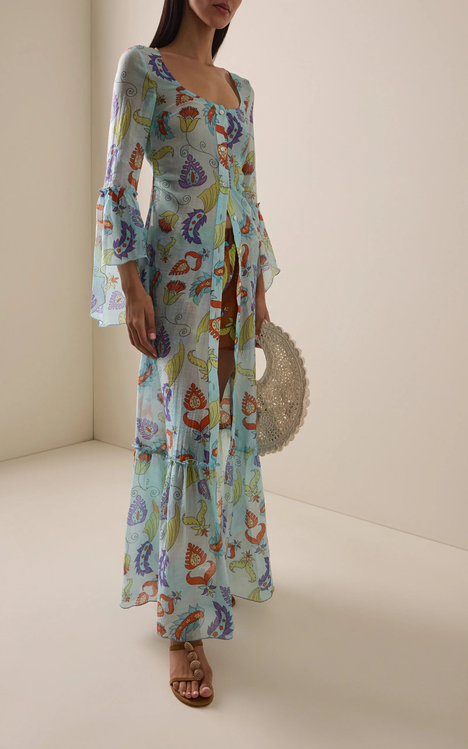 Featuring paisley prints, front button detailing, and dramatic flared bell sleeves, this maxi is the ultimate statement piece for sun-drenched resort getaways.