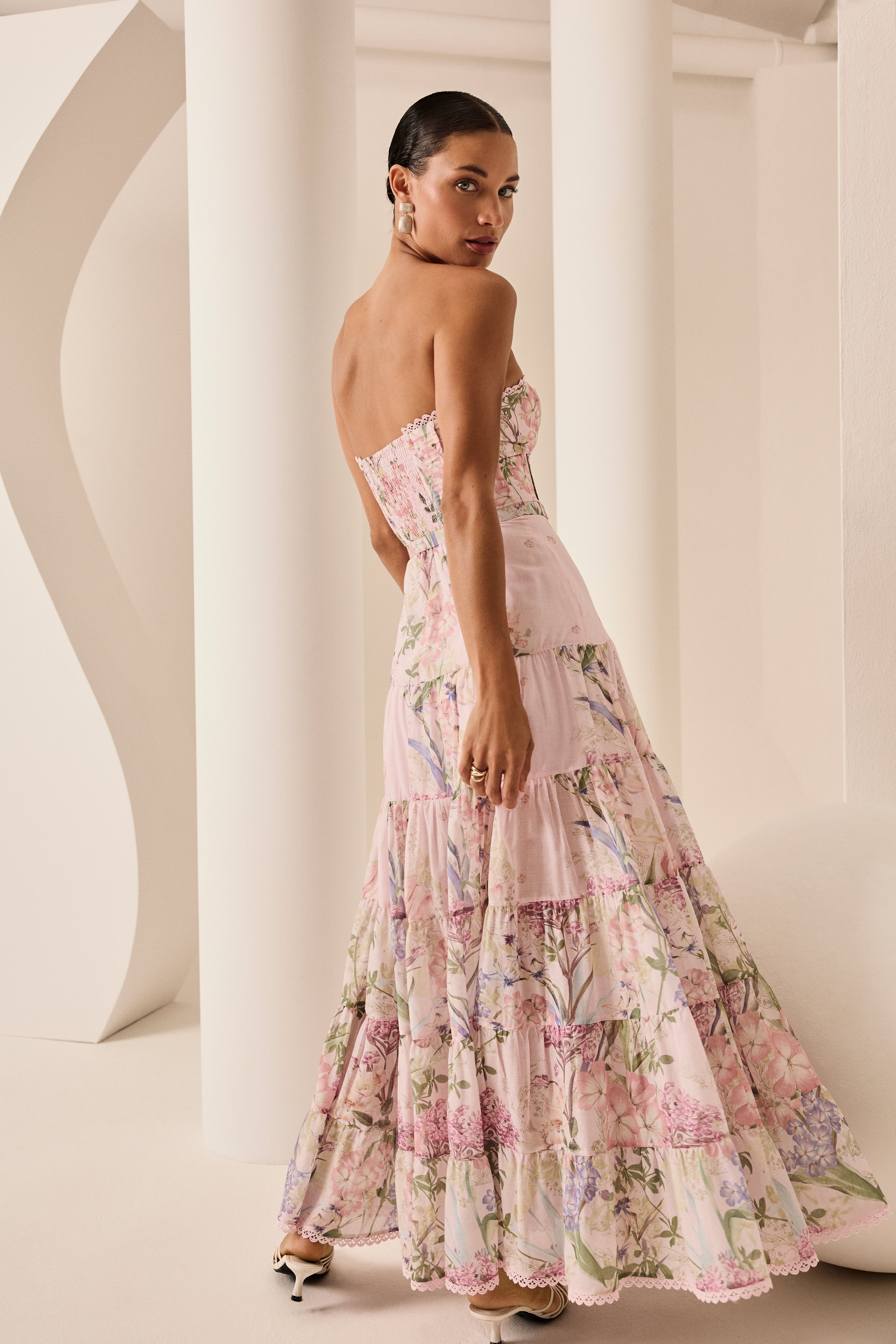 Featuring a chic strapless neckline with lace trim, this maxi gown is the ultimate statement piece for sun-drenched coastal getaways.