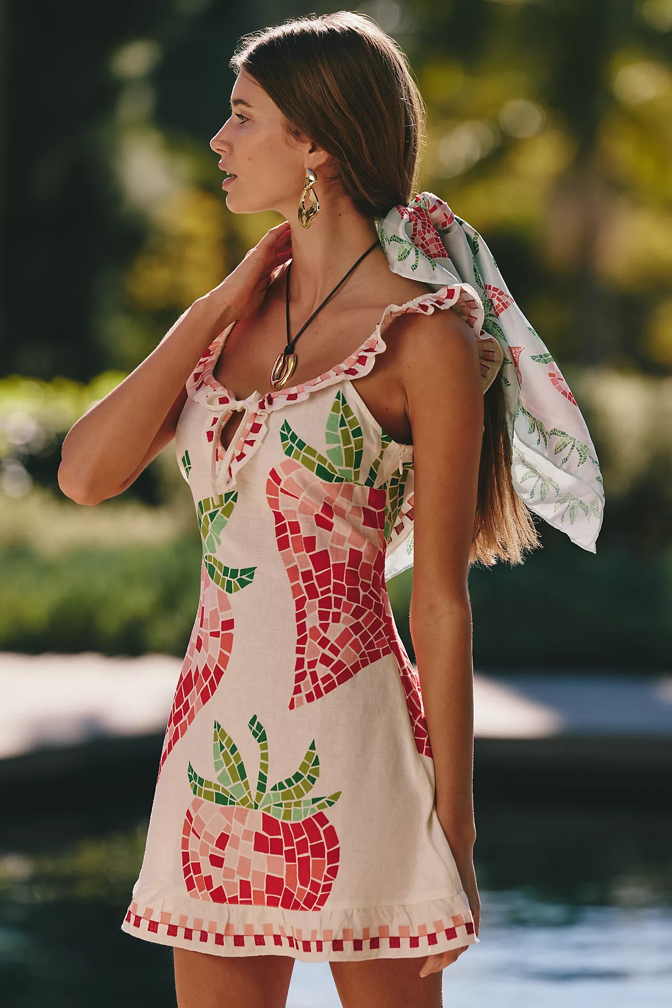 Featuring a pink and green mosaic-style strawberry graphics, delicate ruffle-trimmed straps,this dress is the ultimate statement piece for sun-soaked getaways.