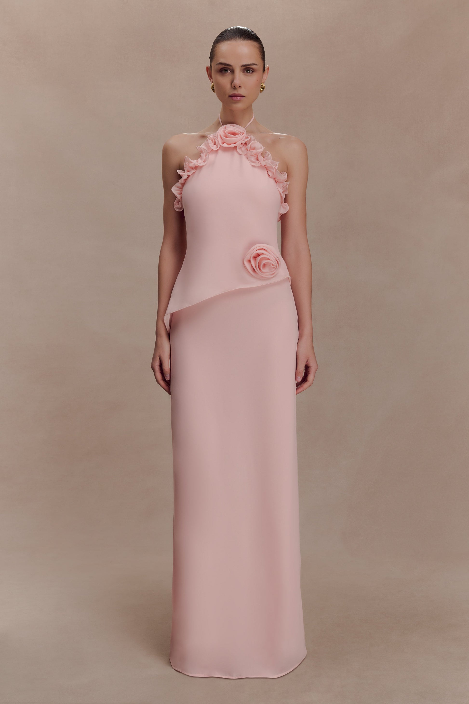 Featuring ruffled rosettes, a structural asymmetric bodice overlay,this maxi gown is the ultimate statement piece for luxury resort getaways.