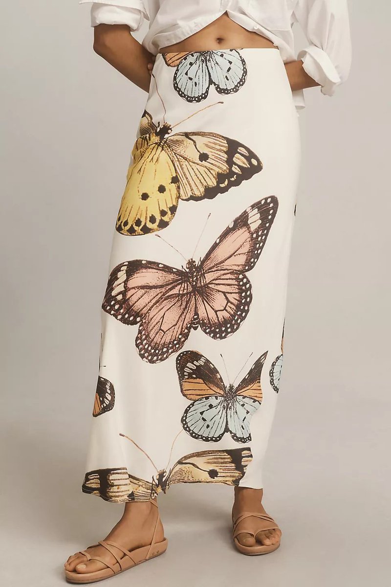 Featuring a clean white base with bold, butterfly graphics in soft pastel tones, this skirt is the ultimate piece for sun-drenched coastal getaways and stylish daytime outings.