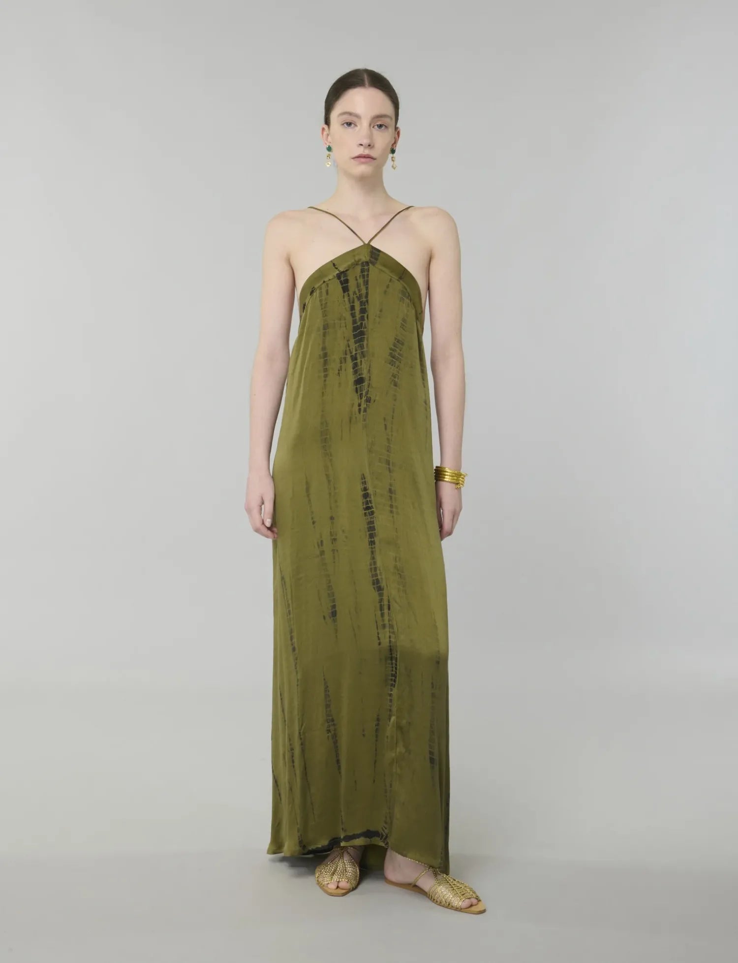 Featuring a rich olive green tone, a delicate halter neckline with thin straps,this maxi gown is the ultimate statement piece for luxury resort getaways.