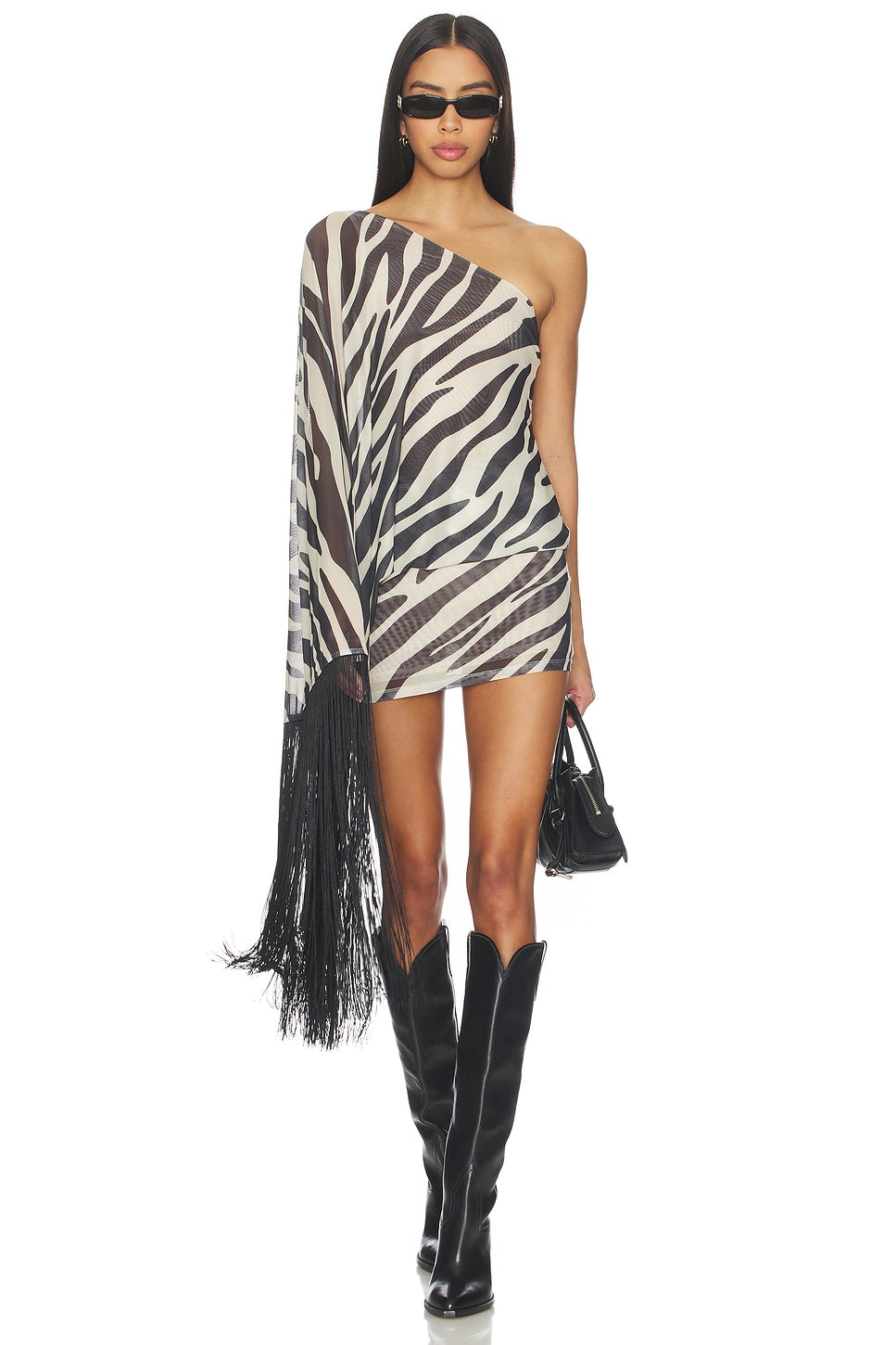 Featuring a one-shoulder neckline with an elongated draped sleeve finished with long black fringe, this dress is the ultimate piece for luxury resort getaways.