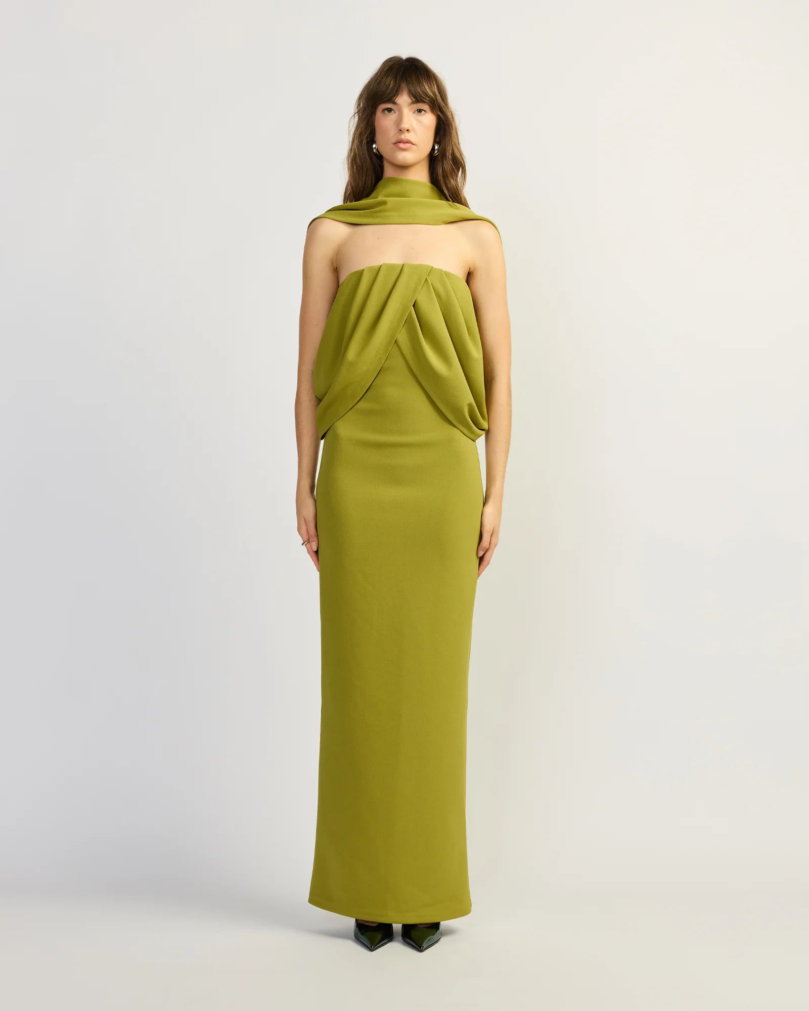 Featuring a sleek strapless silhouette with dramatic front draping, this maxi gown is the ultimate statement piece for luxury resort getaways.