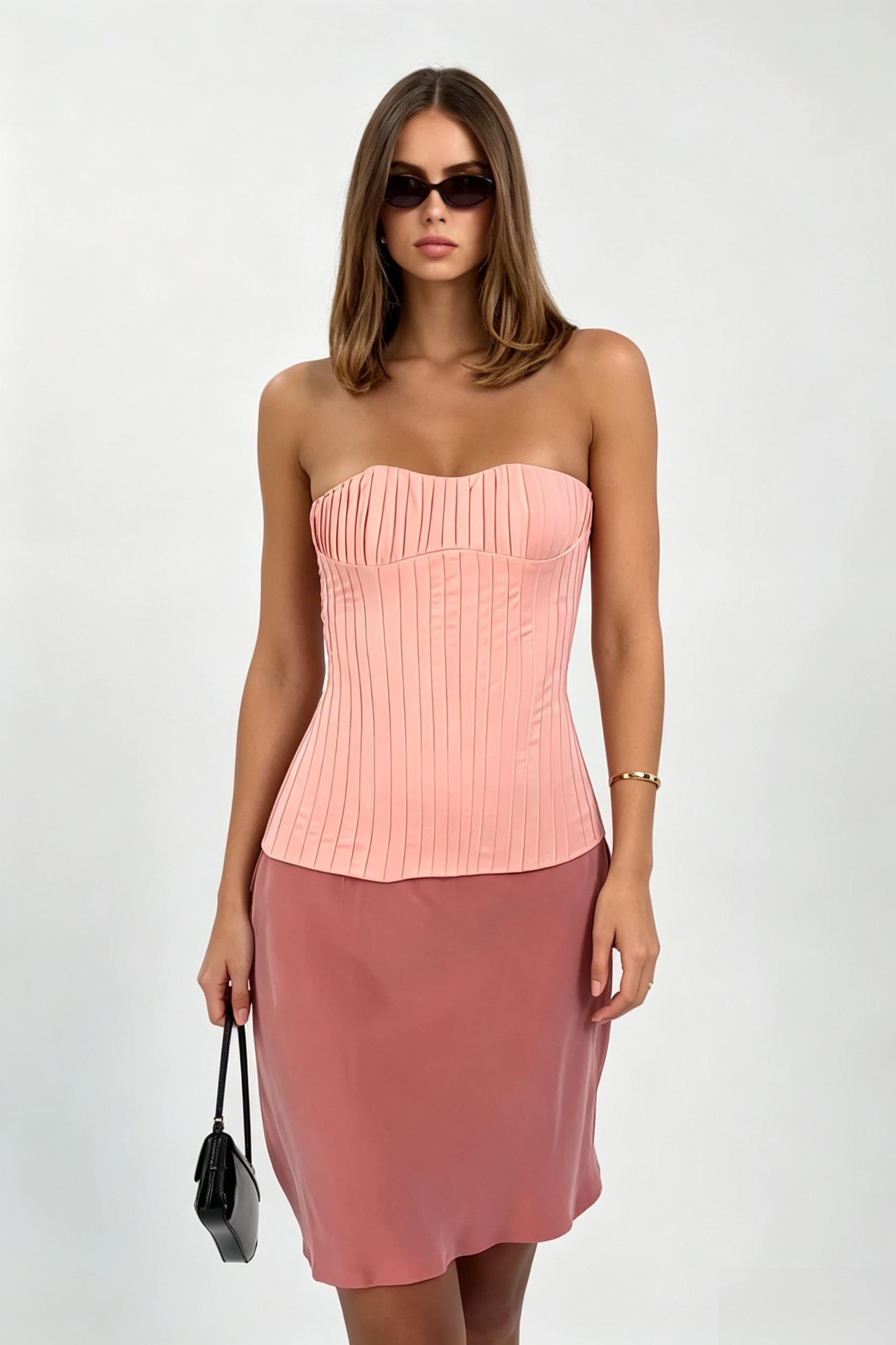 Featuring a structured peach-pink pleated strapless corset bodice paired, this coordinated set is the ultimate statement piece for luxury resort getaways.