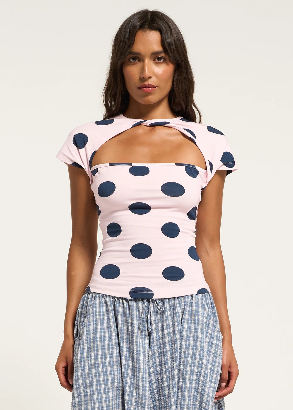 Featuring a creative front cutout keyhole neckline with a twisted shoulder detail, this top is the ultimate statement piece for chic coastal getaways.