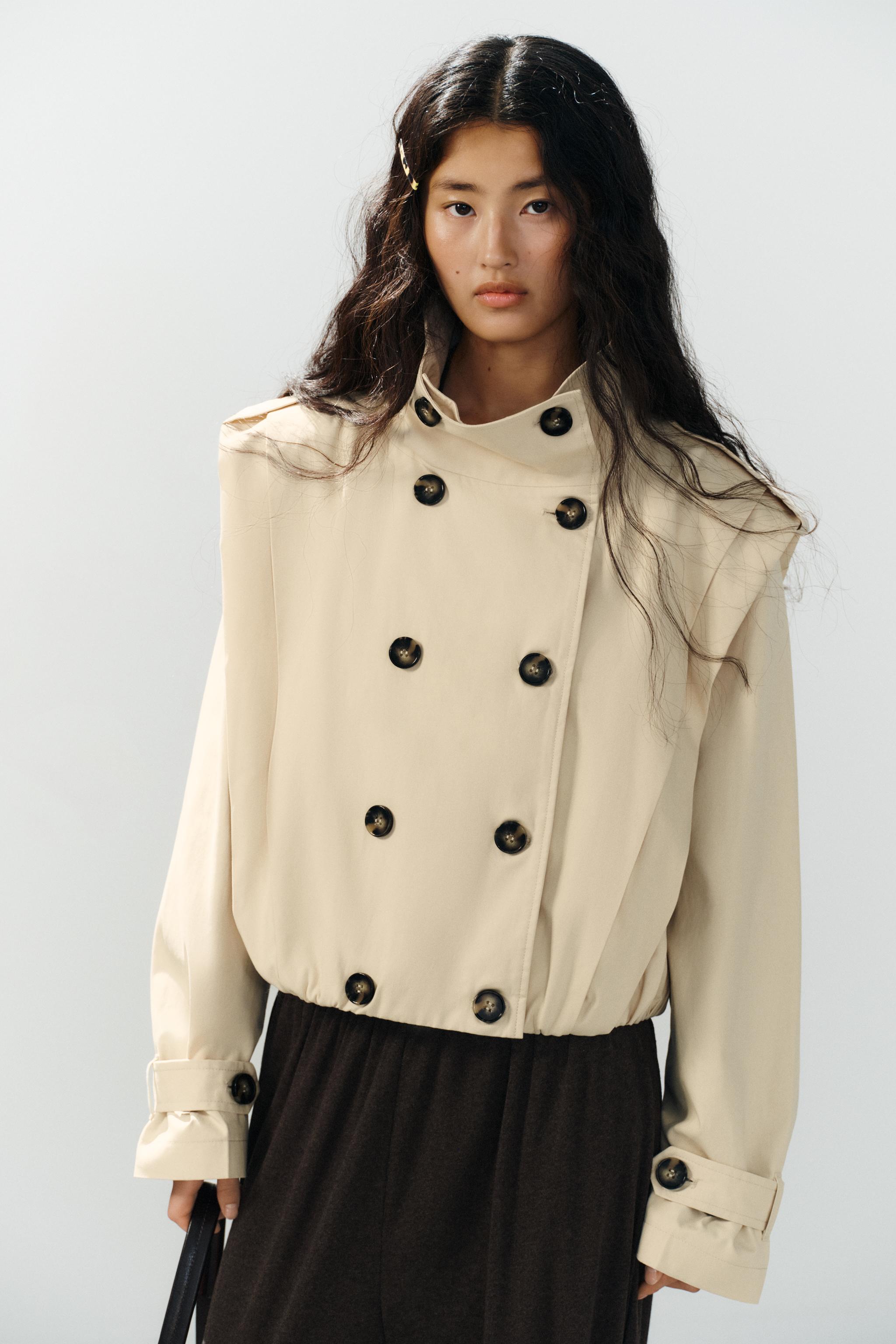 Featuring a structural stand collar, double-breasted tortoiseshell button front,this jacket is the ultimate statement piece for transitional weather.