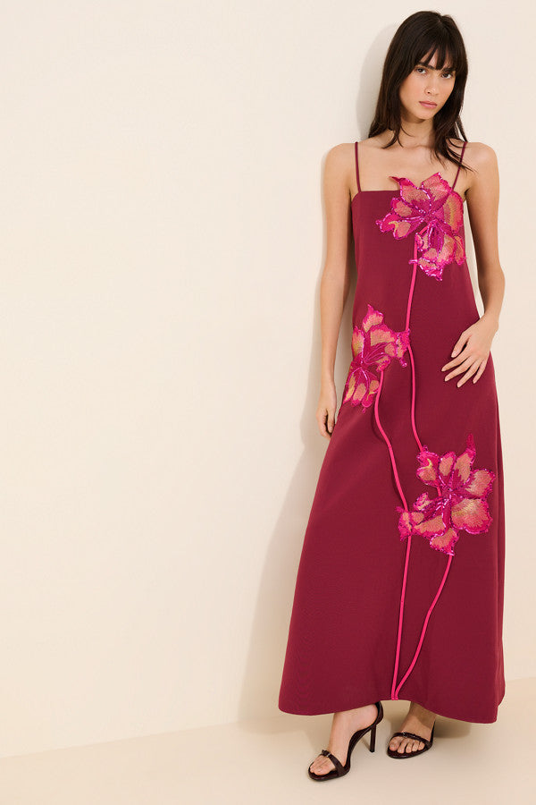 Featuring a striking oversized sequin flower appliqués, contrasting decorative piping trails,this dress is the ultimate statement piece for luxury resort evenings.