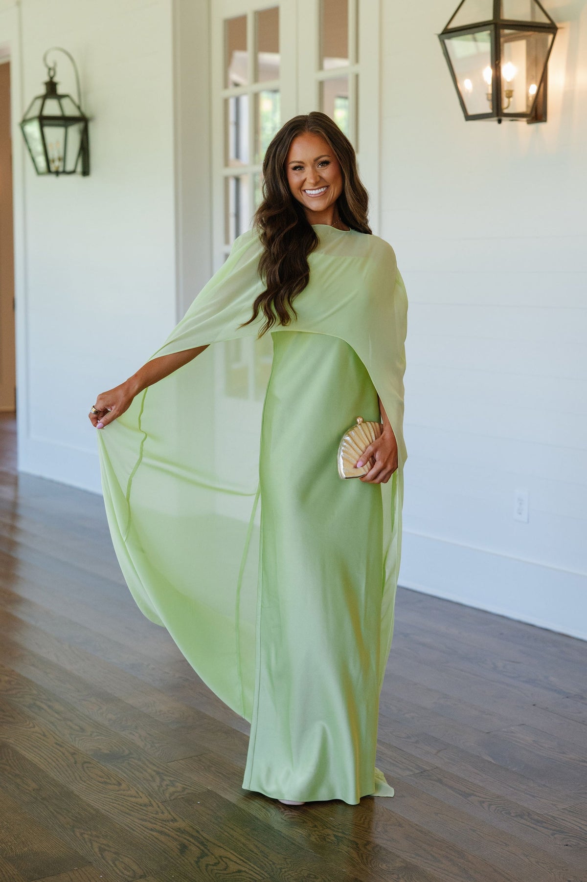 Featuring a sweeping sheer chiffon cape overlay,this dress is the ultimate statement piece for luxury resort evenings and high-end galas.