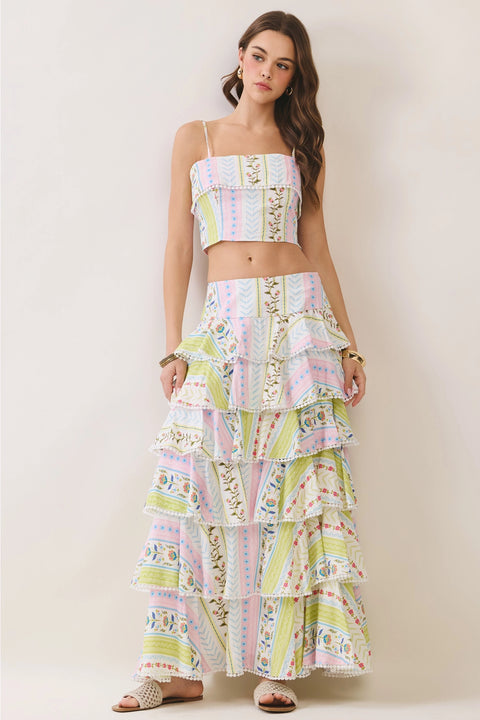 Featuring a cropped cami top, and a multi-tiered ruffled maxi skirt, this coordinated set is the ultimate statement piece for luxury resort getaways.