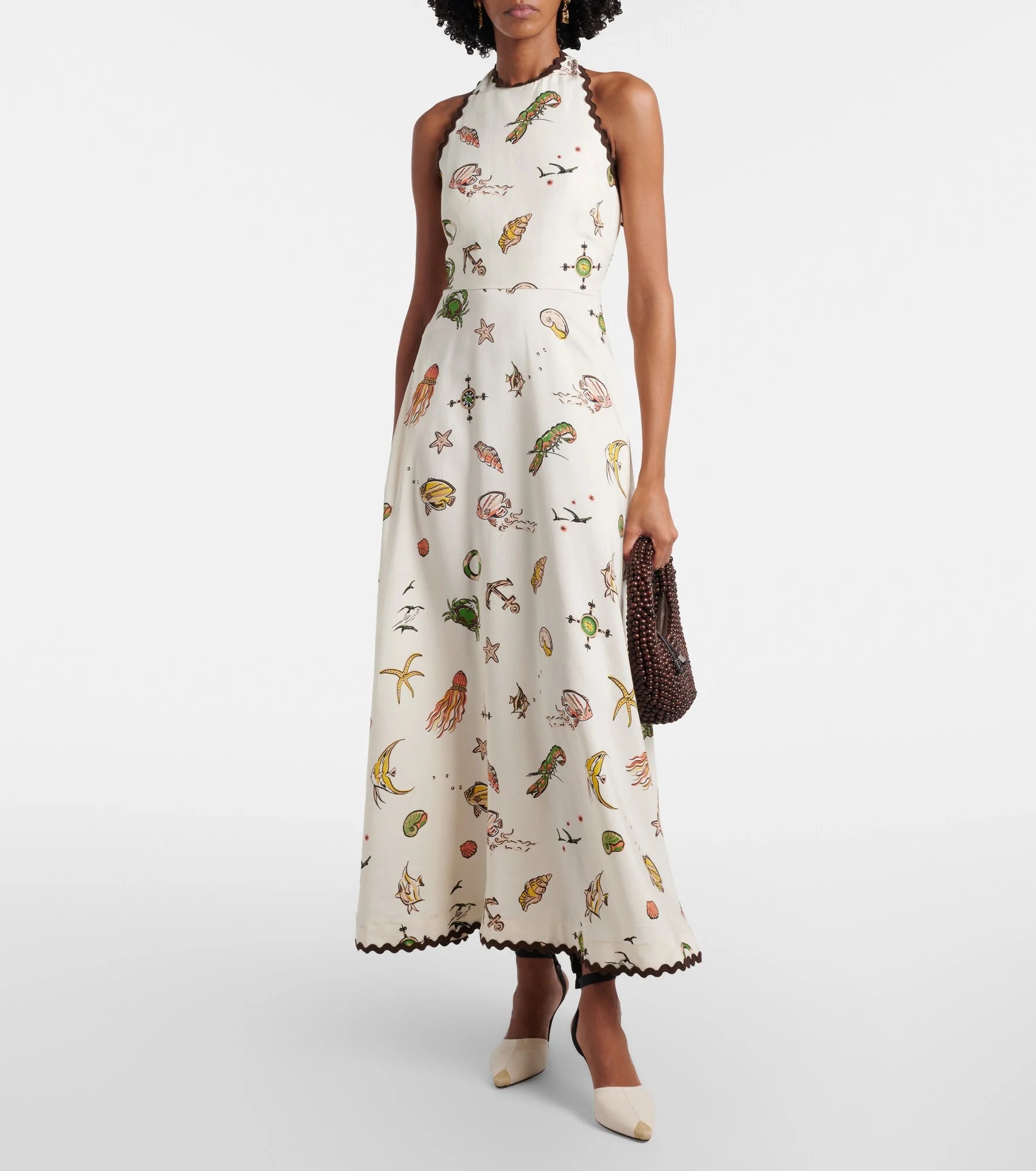Featuring a compasses, a halter neckline with scalloped contrast trim,this dress is the ultimate statement piece for luxury resort getaways.