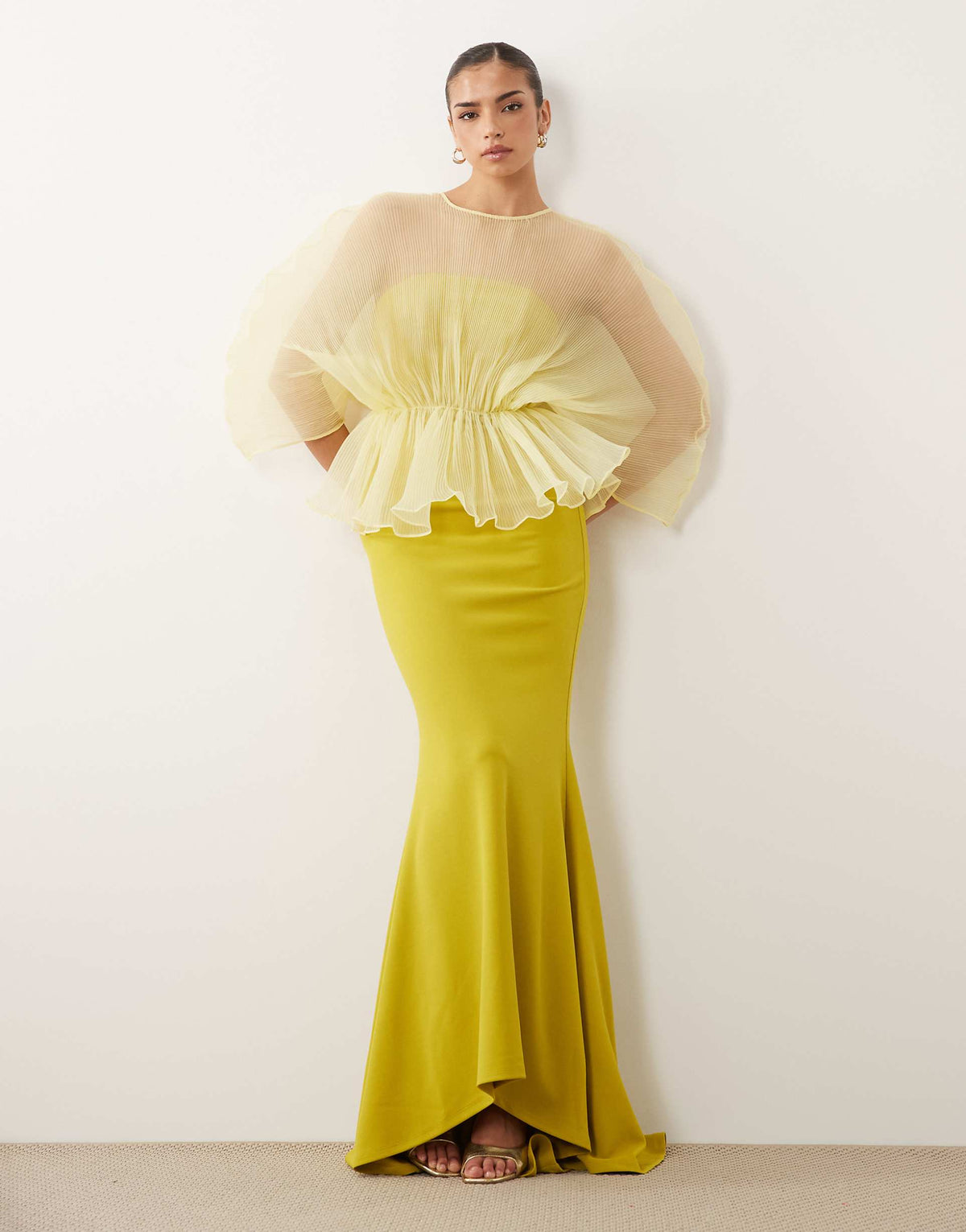 Featuring a airy micro-pleated sheer cape-style overlay top,paired with a sleek mermaid skirt,this set is the ultimate statement piece for luxury resort evenings.