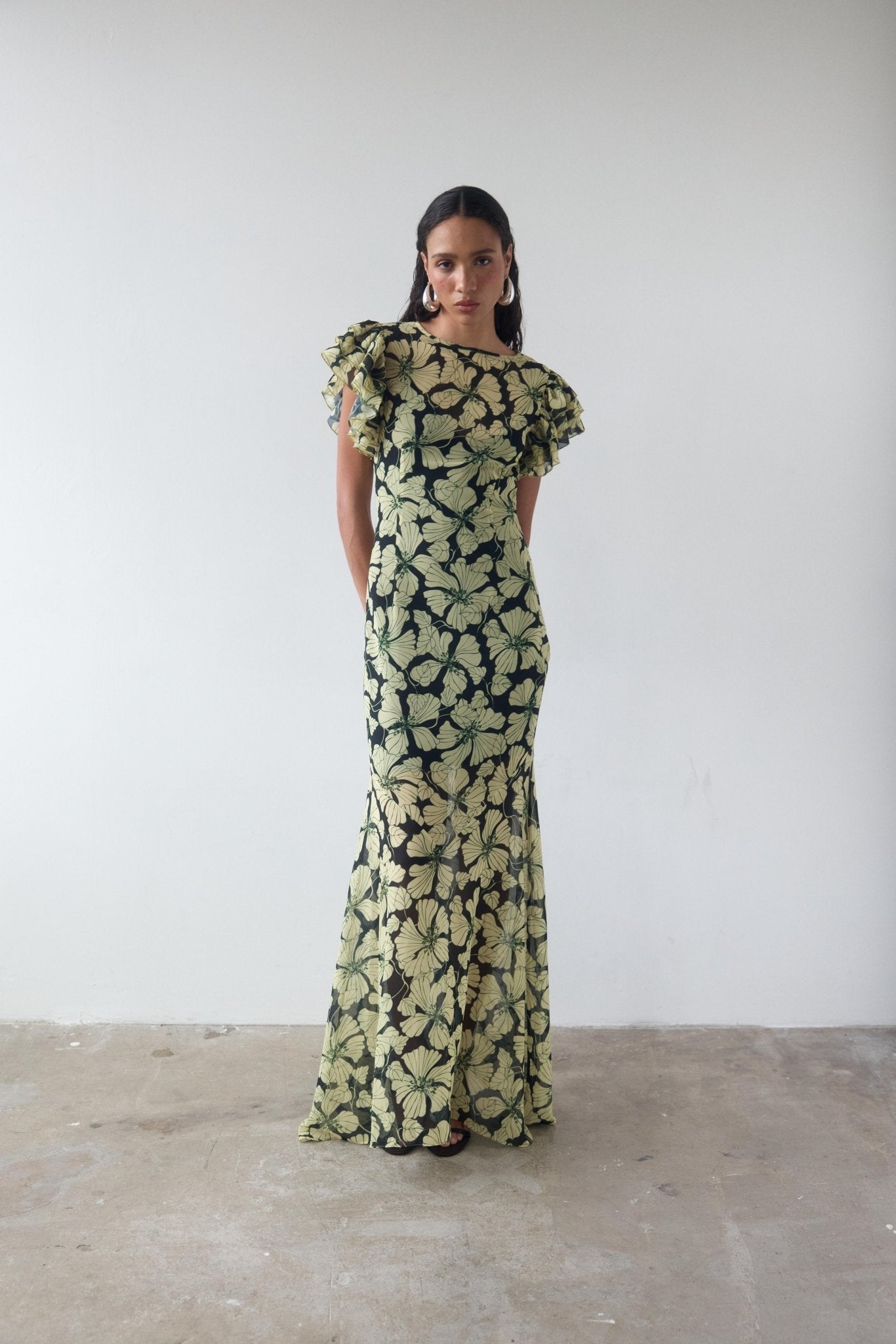 Featuring a olive floral print, tactile crinkle chiffon fabric,this dress is the ultimate statement piece for luxury resort evenings.