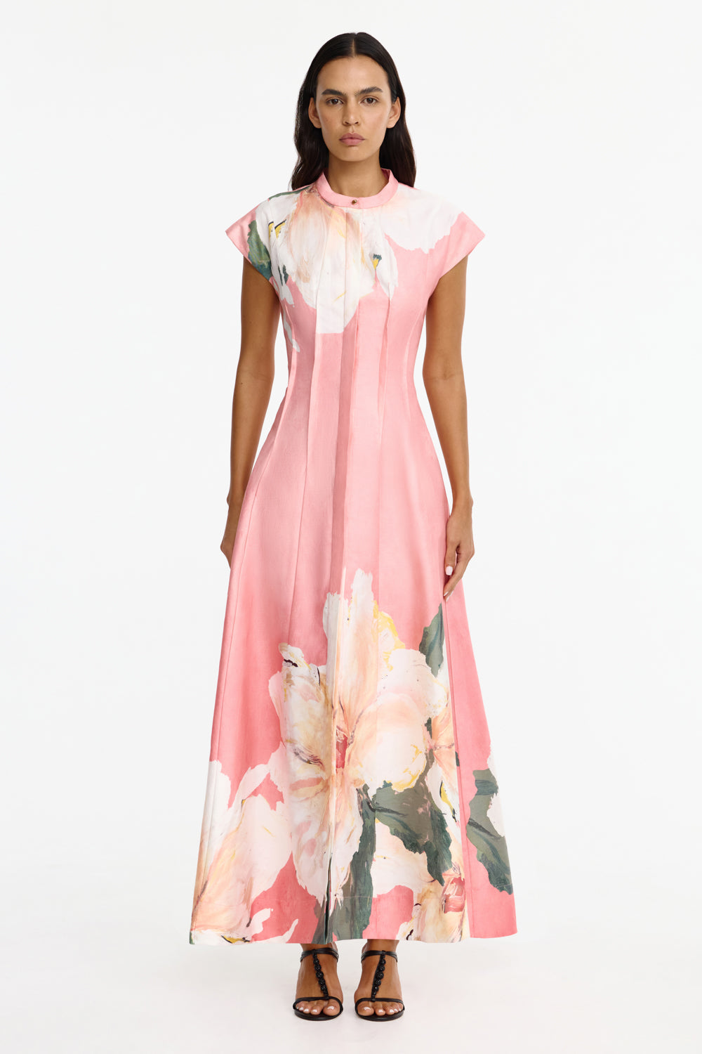 Featuring a watercolor floral prints, a structured mock neckline, delicate front pintucks,this dress is the ultimate statement piece for luxury resort getaways.
