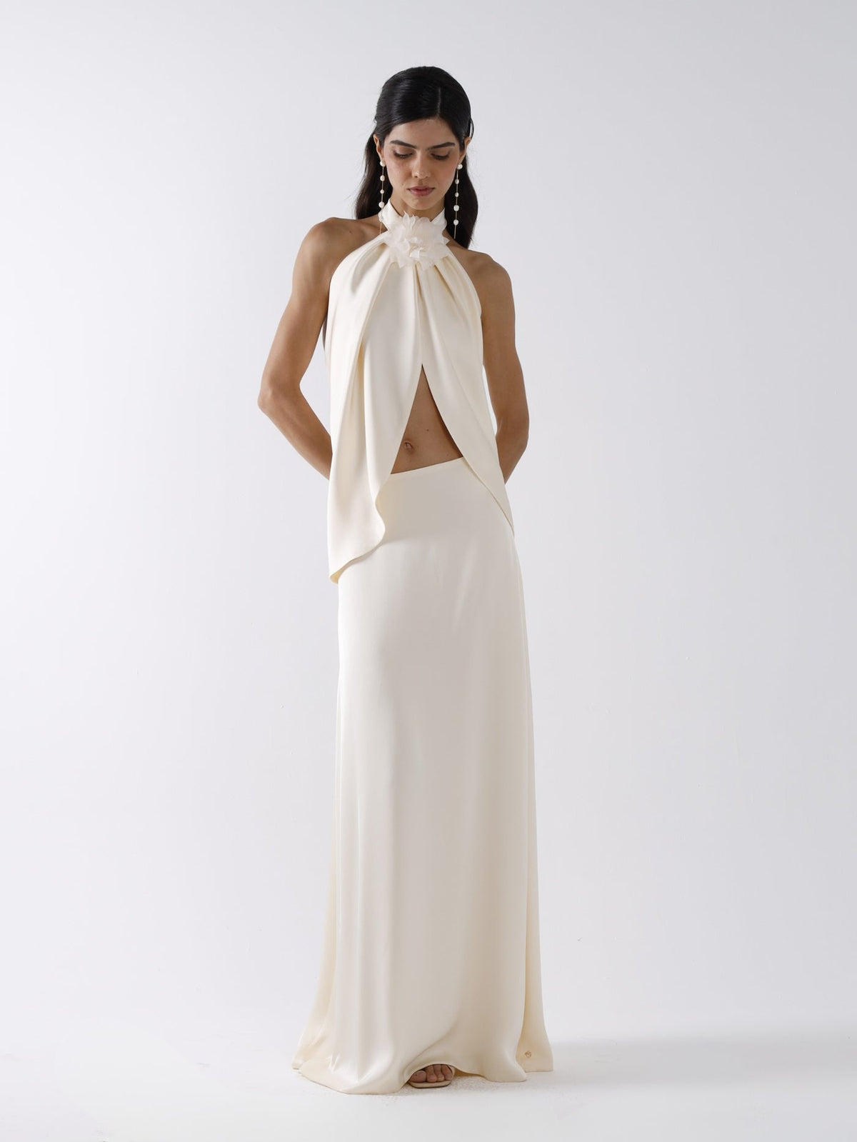 Featuring a delicate fabric rosette, a dramatic draped open-front crop top,this coordinated set is the ultimate statement piece for luxury resort getaways.