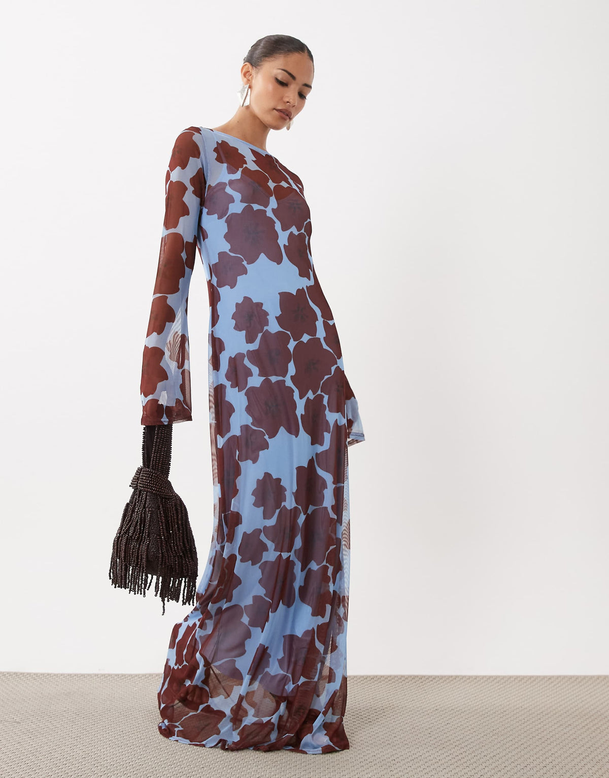 Featuring a floral print, a classic boat neckline, long fitted sleeves with flared cuffs,this dress is the ultimate statement piece for luxury resort getaways.