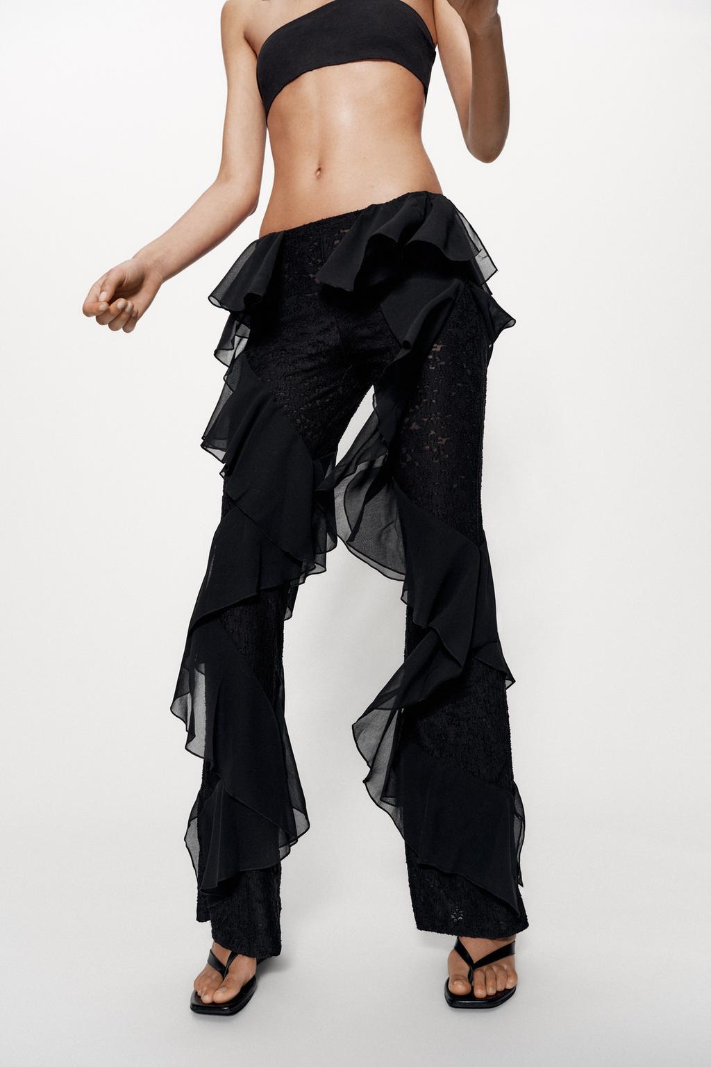 Featuring a fitted black lace base adorned, flowing chiffon ruffles cascading, these trousers are the ultimate statement piece for luxury resort getaways.