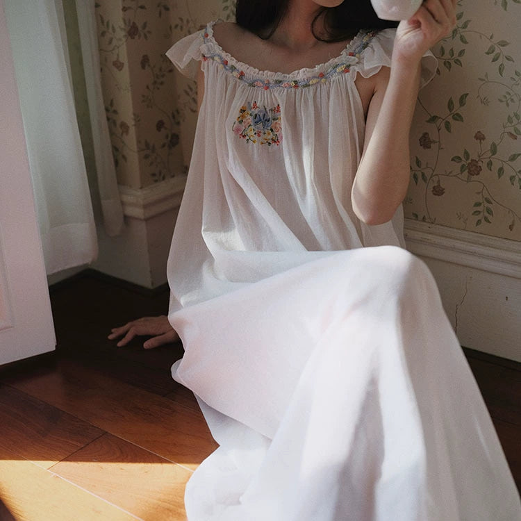 Featuring a gathered scoop neckline adorned with floral embroidery, this nightgown is the ultimate statement piece for luxury resort lounging.