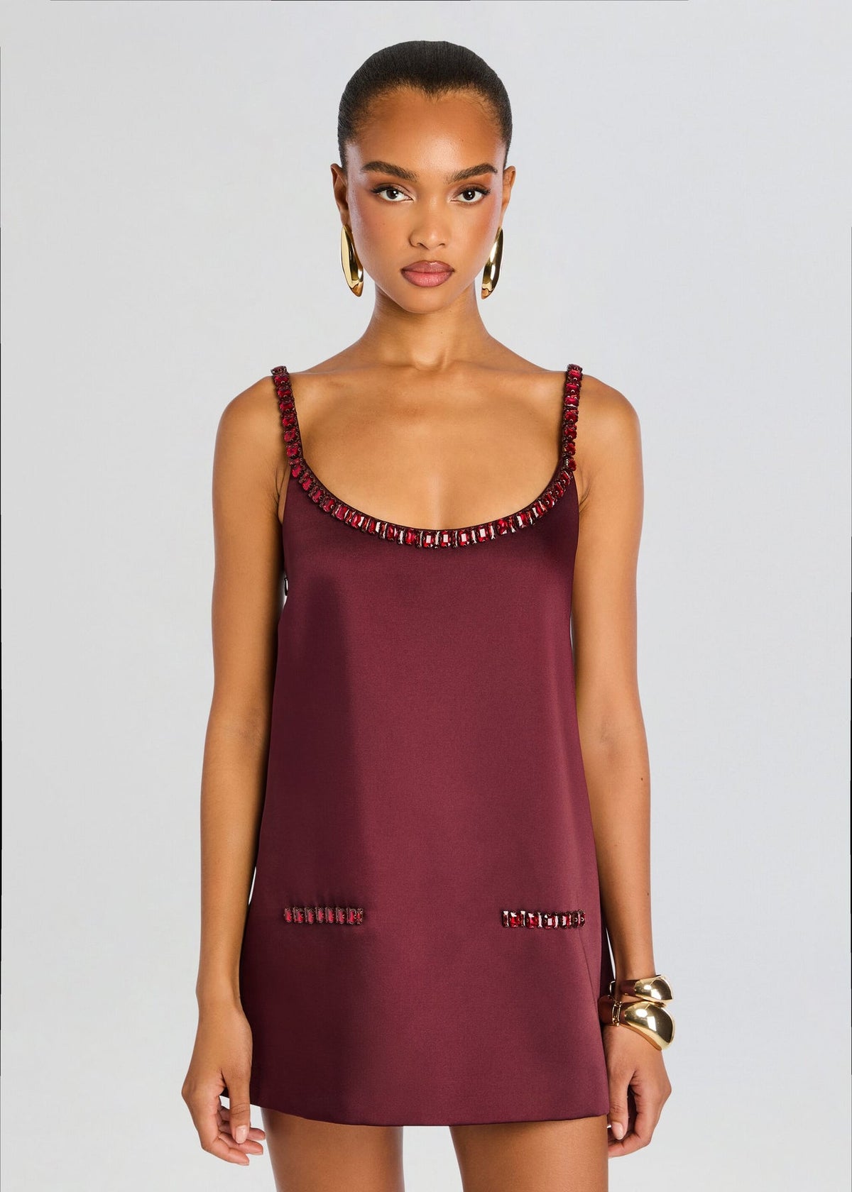 Featuring a shimmering red crystals, and matching crystal-trimmed faux pockets, this dress is the ultimate statement piece for luxury resort getaways.