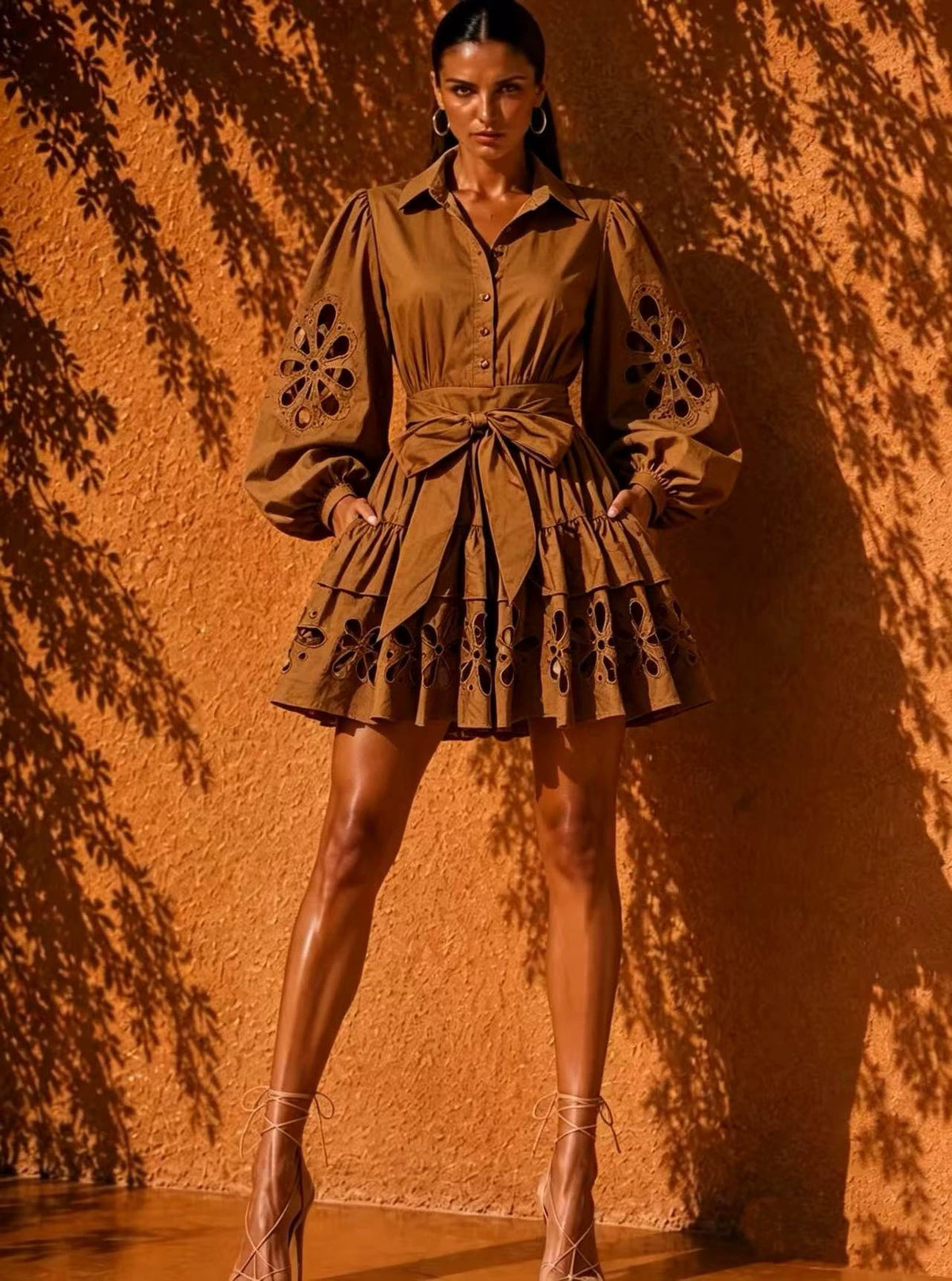 Featuring a dramatic floral cut-out eyelet details on the blouson sleeves and tiered ruffled hem,this dress is the ultimate statement piece for luxury resort getaways.